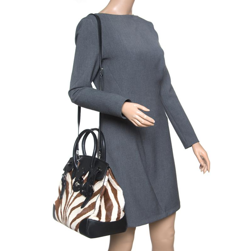 This Ralph Lauren Ricky tote is simply breathtaking. Meticulously crafted from zebra print pony hair and leather, the black tote delights not only with its appeal but structure as well. It is held by two top handles and a removable shoulder strap,