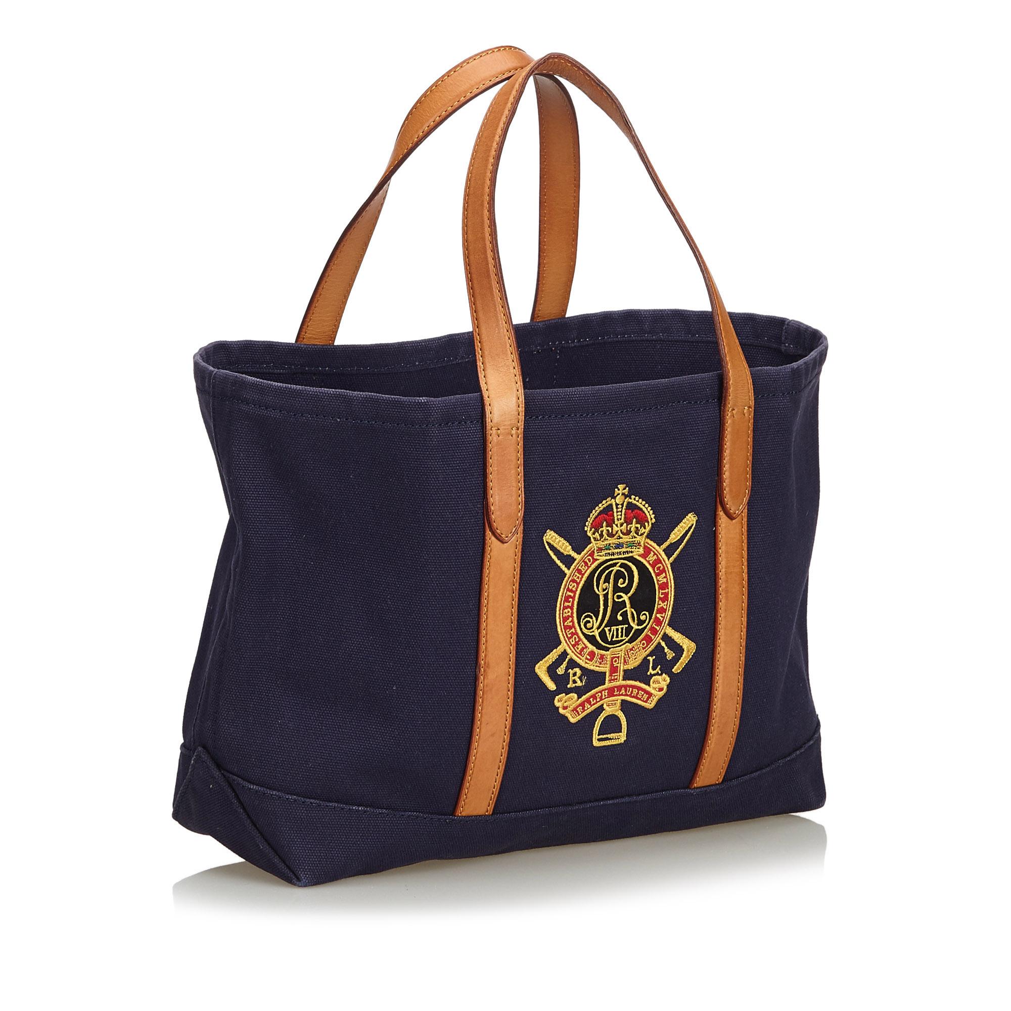 This tote bag features a canvas body with embroidered details and leather trim, flat leather straps, a top zip closure, and interior zip and slip pockets. It carries as B+ condition rating.

Inclusions: 
This item does not come with