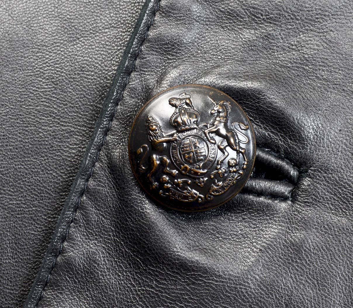Ralph Lauren blue label buttery leather jacket has a fitted bodice with princess seams and a waist peplum. The jacket has a simple stand collar, shoulder epaulettes, and a button front with metal medieval style crest buttons. There is a single waist