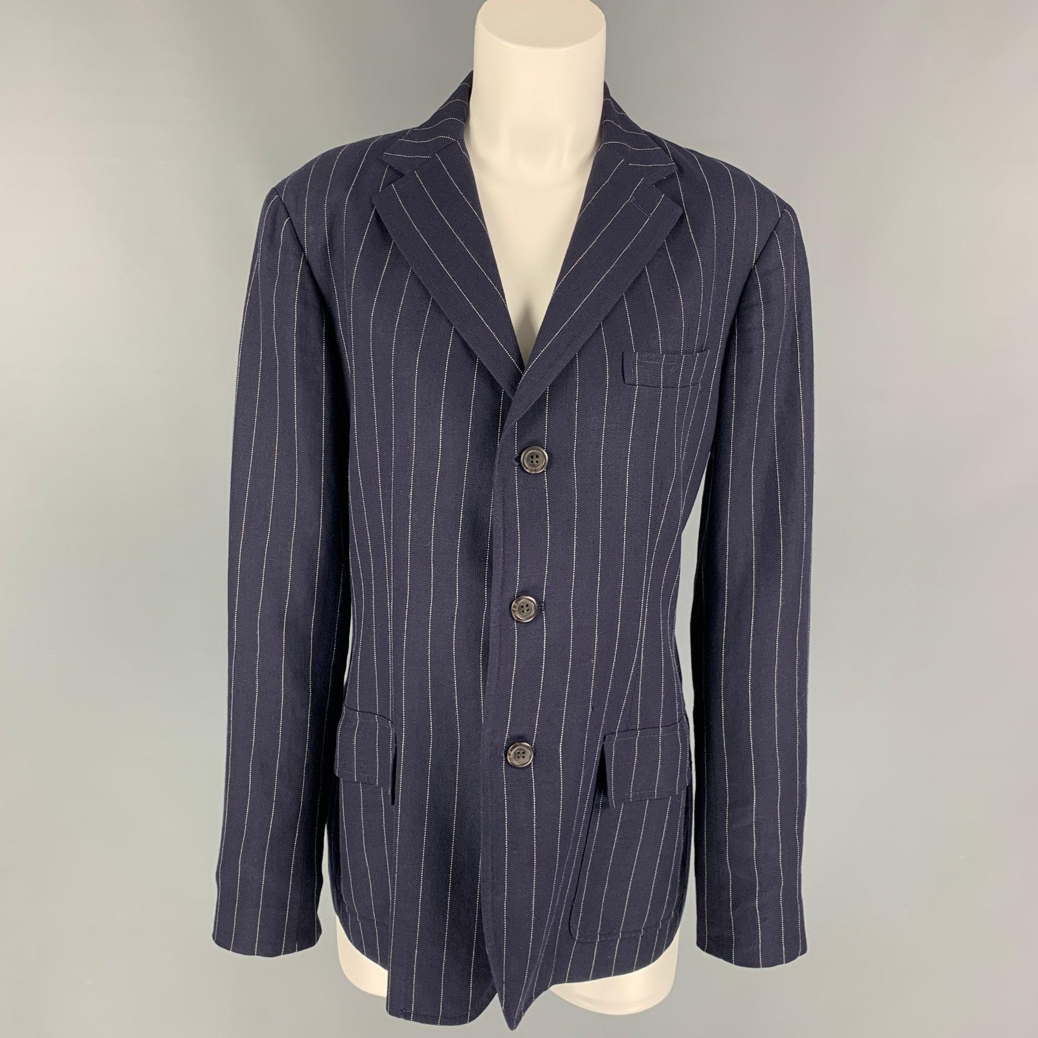 RALPH LAUREN 'Blue Label' blazer comes in a navy & white pinstripe linen blend with a full liner featuring a notch lapel, flap pockets, single back vent, and a three button closure. Matching pants sold separately. Made in Italy. Very Good
Pre-Owned
