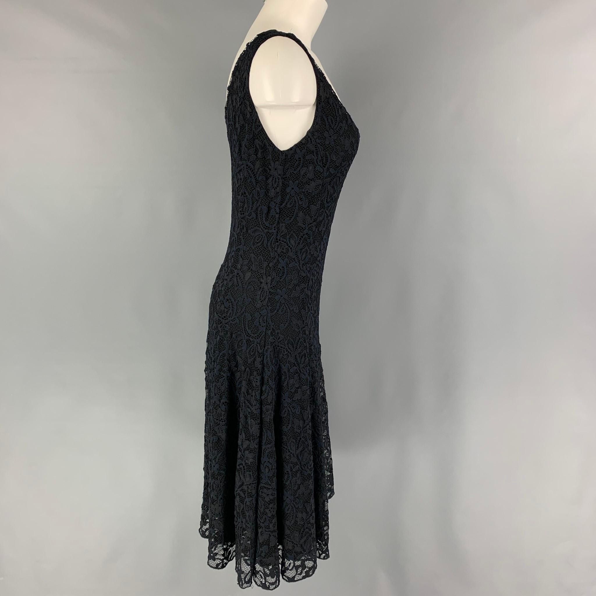 RALPH LAUREN Blue Label dress comes in a navy lace nylon with a slip liner featuring an a-line style, sleeveless, and a v-neck. 

Excellent Pre-Owned Condition.
Marked: L

Measurements:

Bust: 30 in.
Waist: 28 in.
Hip: 36 in.
Length: 32.5 in.