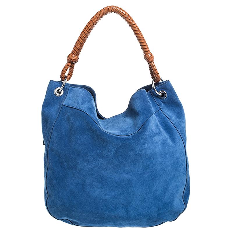 Ralph Lauren presents a meticulously crafted elegant handbag for the fashionable you. Crafted in Italy, it is made of nubuck leather and leather. It comes in lovely shades of blue and tan. This hobo has a woven handle, a fabric interior with a zip