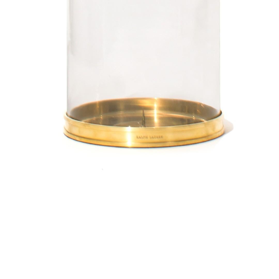 A Ralph Lauren modern hurricane pillar candleholder with glass dome and brass base and trim, USA, circa 2010.
 