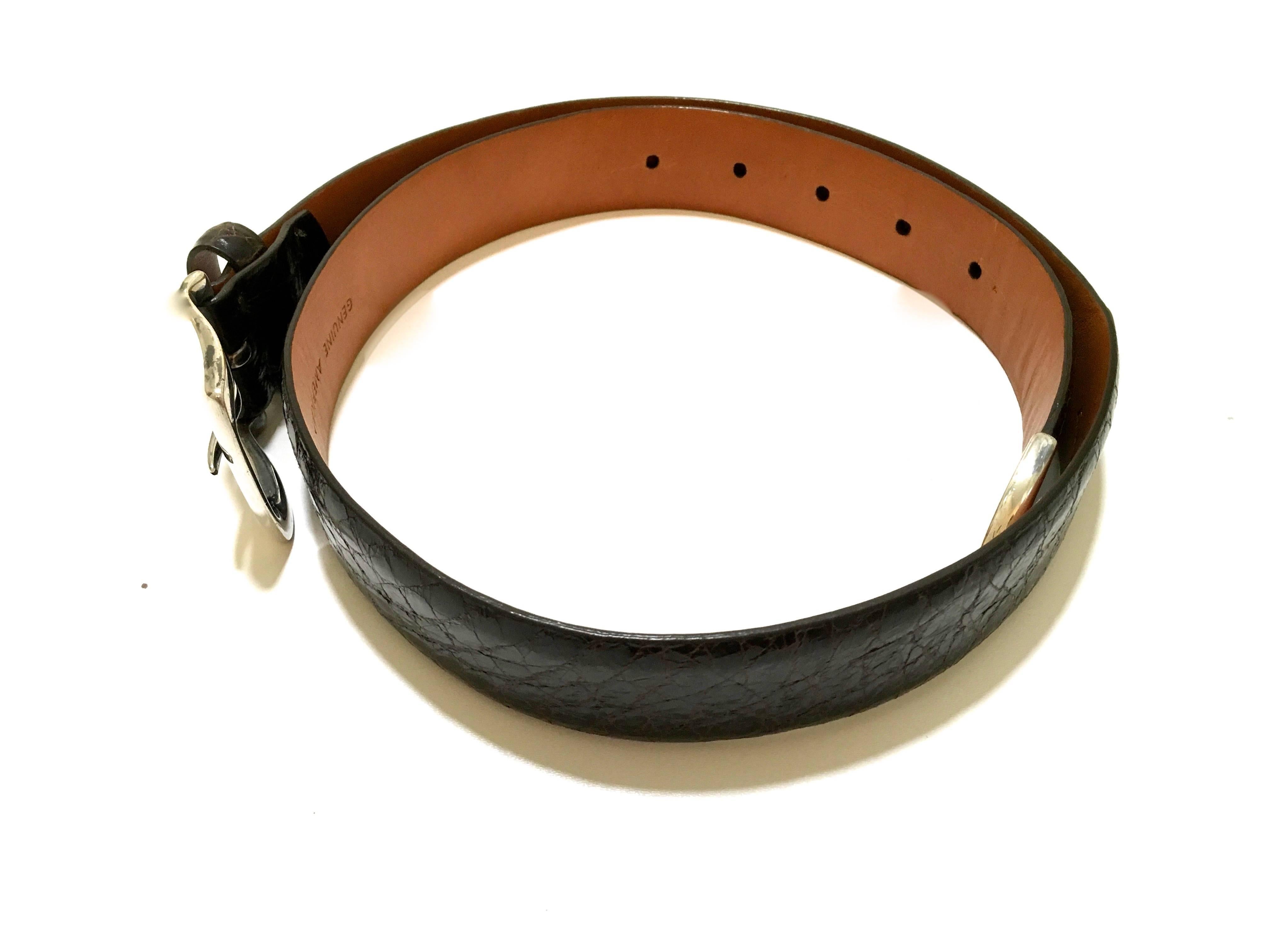 Presented here is a beautiful belt from Ralph Lauren Collection. The belt is made from dark brown alligator and has a gorgeously crafted sterling silver buckle. The tip of the belt is also crafted from sterling silver. The belt is 36 inches in total