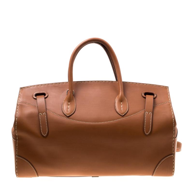This Ralph Lauren Ricky bag is simply breathtaking. Meticulously crafted from leather, the bag delights not only with its appeal but structure as well. It is held by two top handles, a shoulder strap and detailed with silver-tone hardware. It is