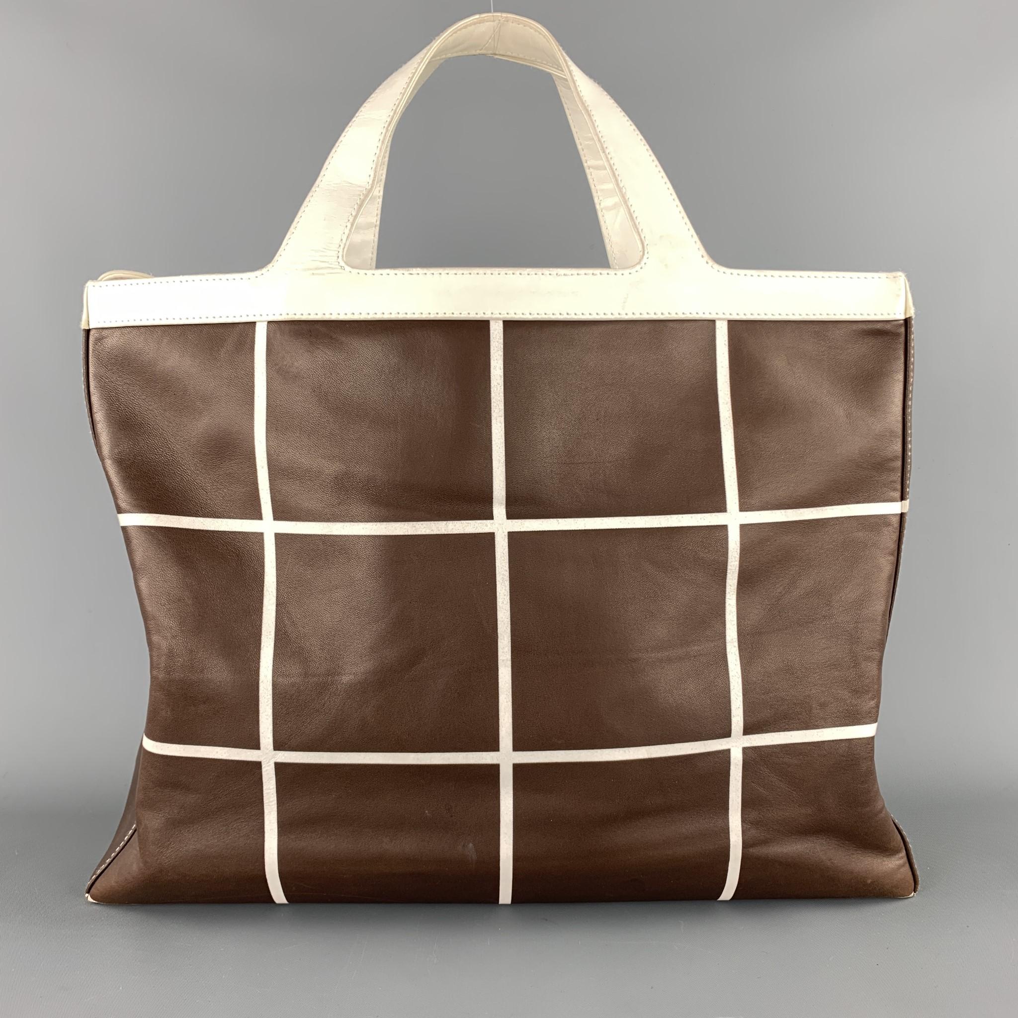 Vintage RALPH LAUREN Tote bag comes in brown and cream grid print leather with cream leather top handles, and gold tone RL hardware top closure. 

Very Good Pre-Owned Condition.

Measurements:

Length: 15.5 in.
Width: 4.75 in.
Height: 12 in. 

SKU: