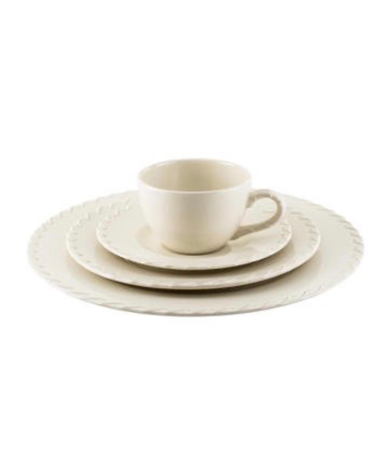 A set of 8 place settings consisting of 32 pieces in the Canyon Road pattern by Ralph Lauren Home.

Made in England, circa 1999-2001.

Features a cream color with whip-stitch pattern and branded mark at undersides. 

Includes the following 32