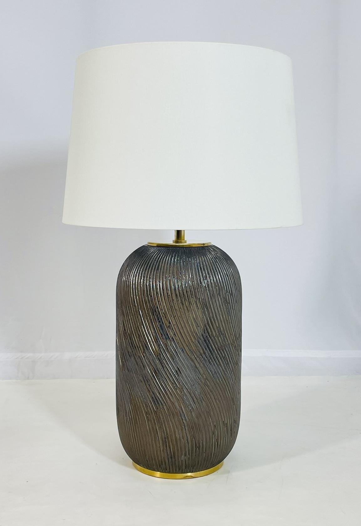 Elegant and timeless, this Ralph Lauren table lamp combines refined design with artisanal craftsmanship, making it an ideal statement piece for sophisticated interiors. The base is crafted from ceramic and finished with a reactive glaze that creates