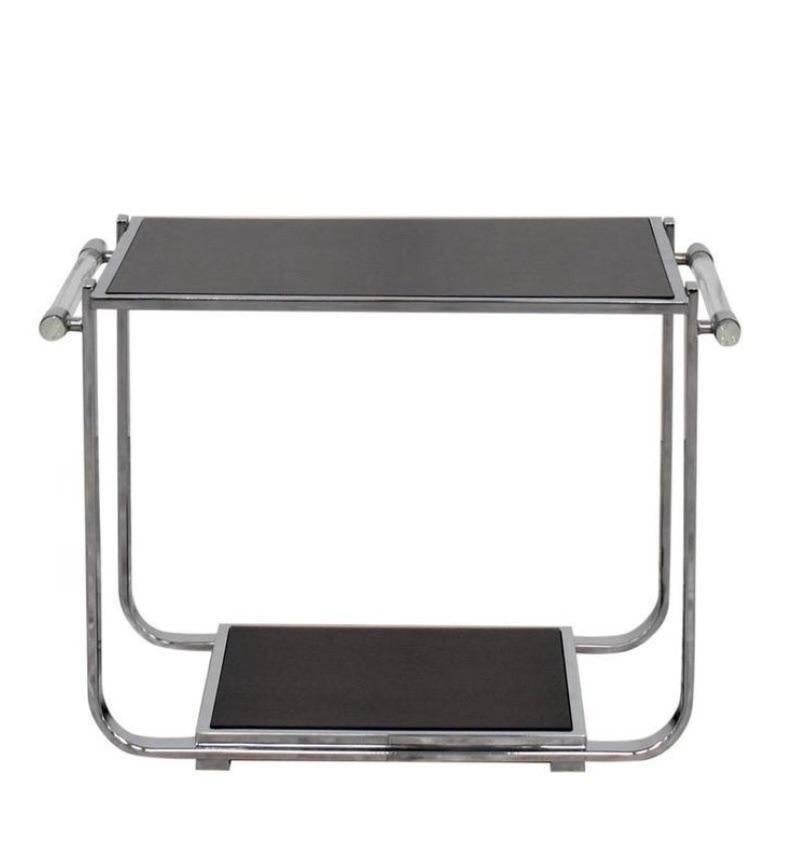 Handsome Avalon two tier tea table by Ralph Lauren Home. This sleek and modern bar table features a polished chrome flat bar frame with tubular Lucite handles and stained wood tops.  A nice size that could also be displayed as an interesting side