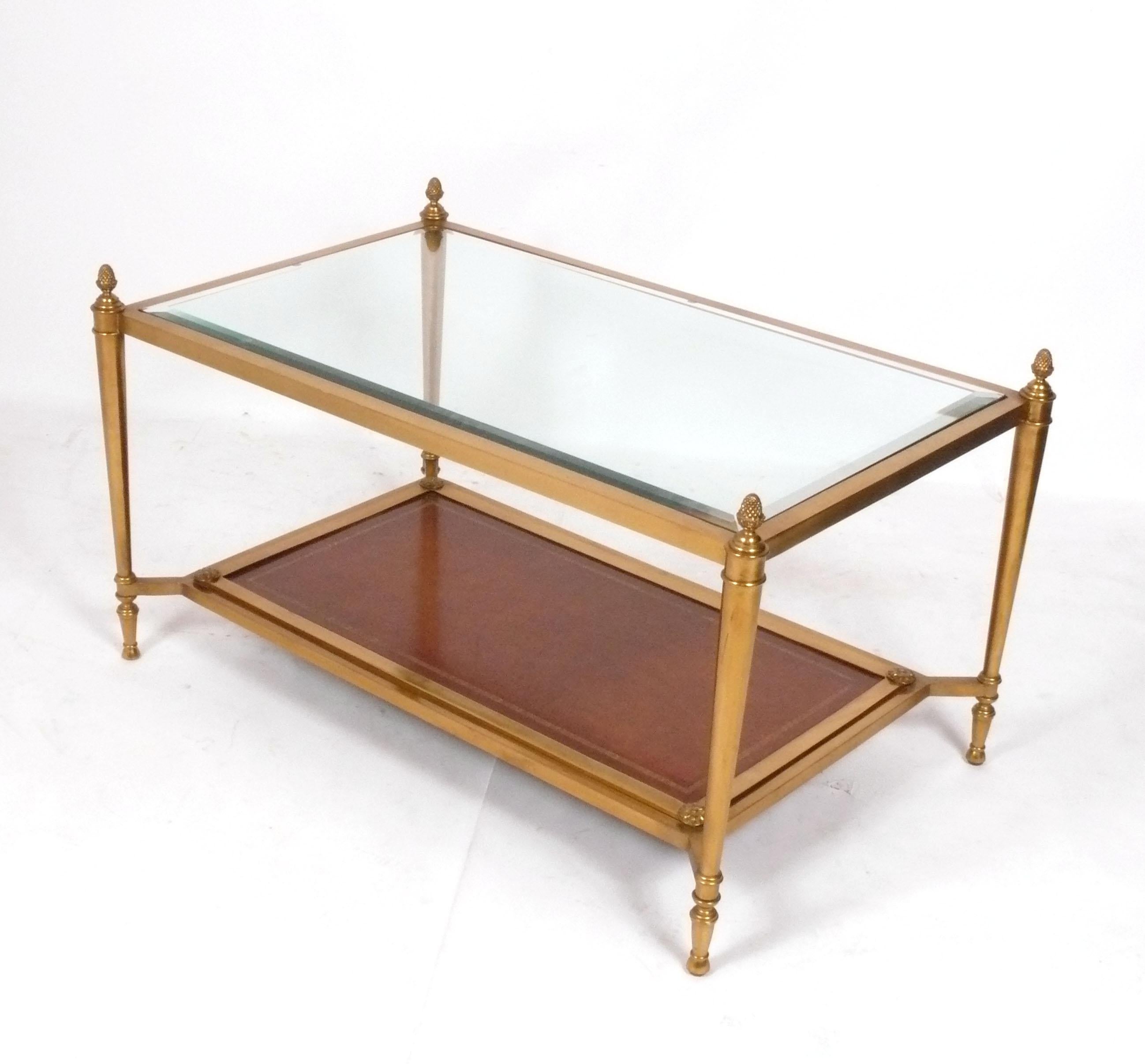 Elegant Regency Style Cognac Leather and Brass Coffee Table, designed for Ralph Lauren, American, circa 2000s. It retains a warm original patina to the leather and brass.