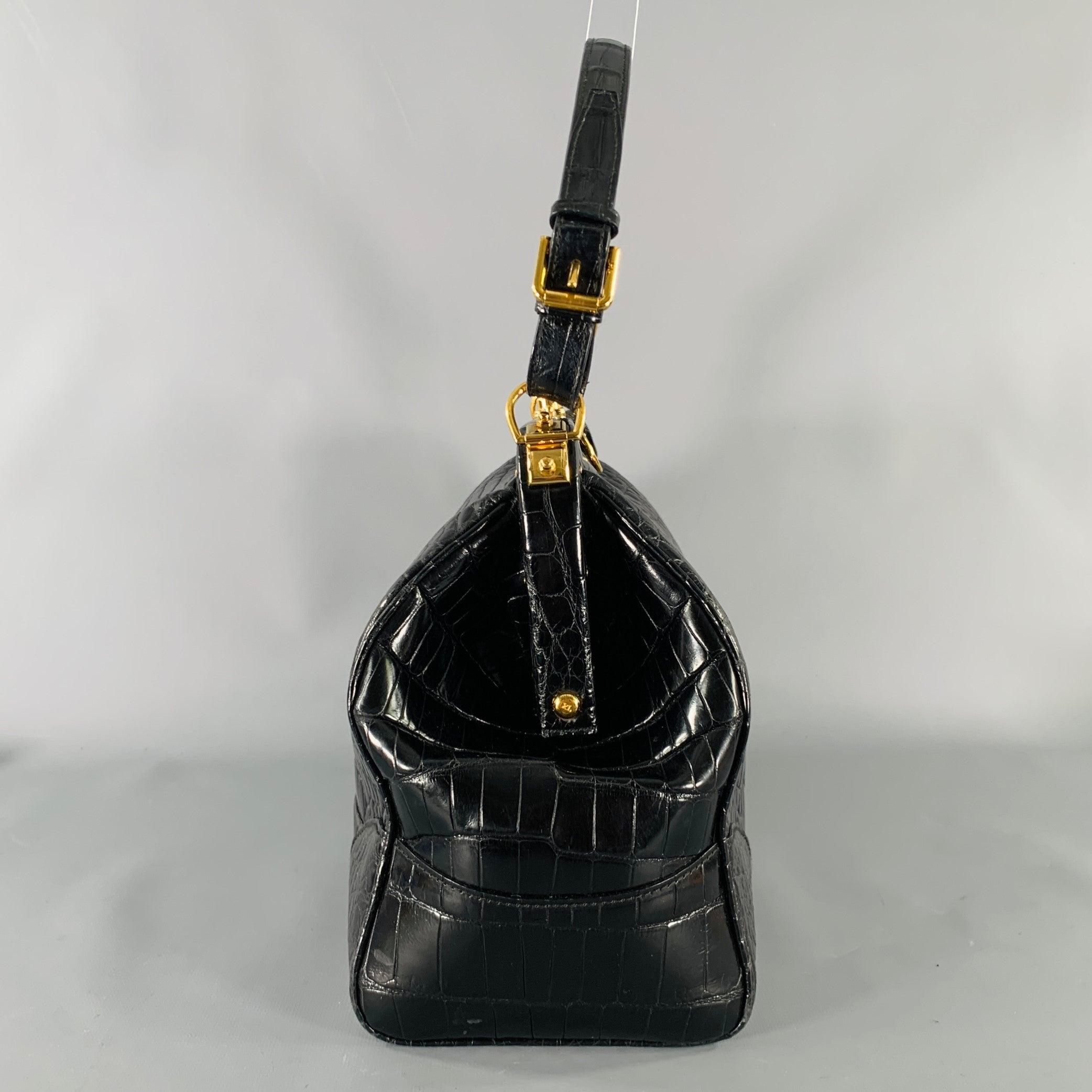 RALPH LAUREN COLLECTION handbag
in a black fabric featuring a doctor's bag style with top handles, alligator pattern, and push lock closure. Comes with key.Very Good Pre-Owned Condition. Light wear. 

Measurements: 
  Length: 14 inches Width: 5.5