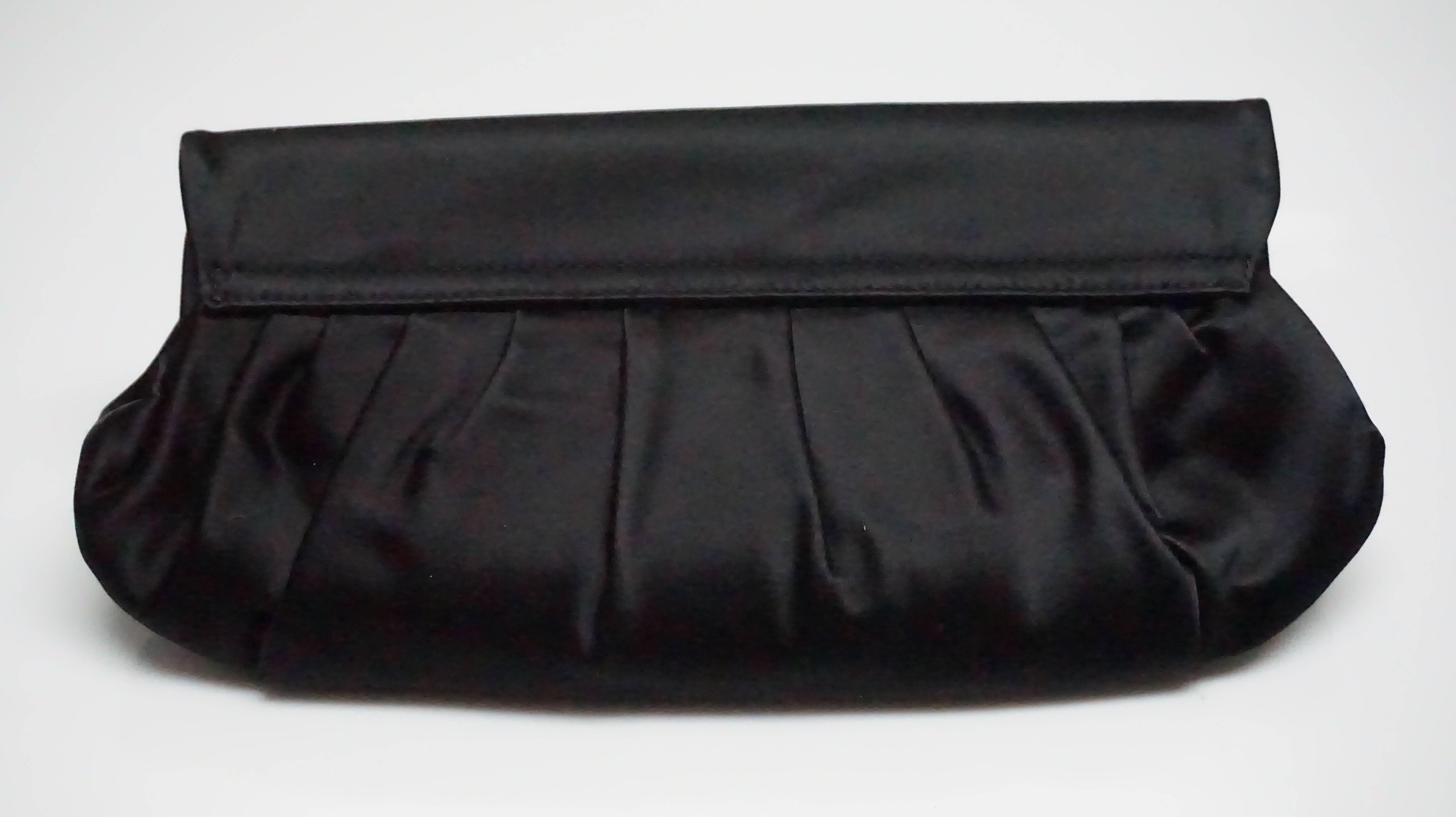 Ralph Lauren Collection Black Silk Clutch  This beautiful clutch is completely silk with two magnetic closures. It has one main compartment and one small interior pocket. It comes with a duster. This clutch is in excellent
