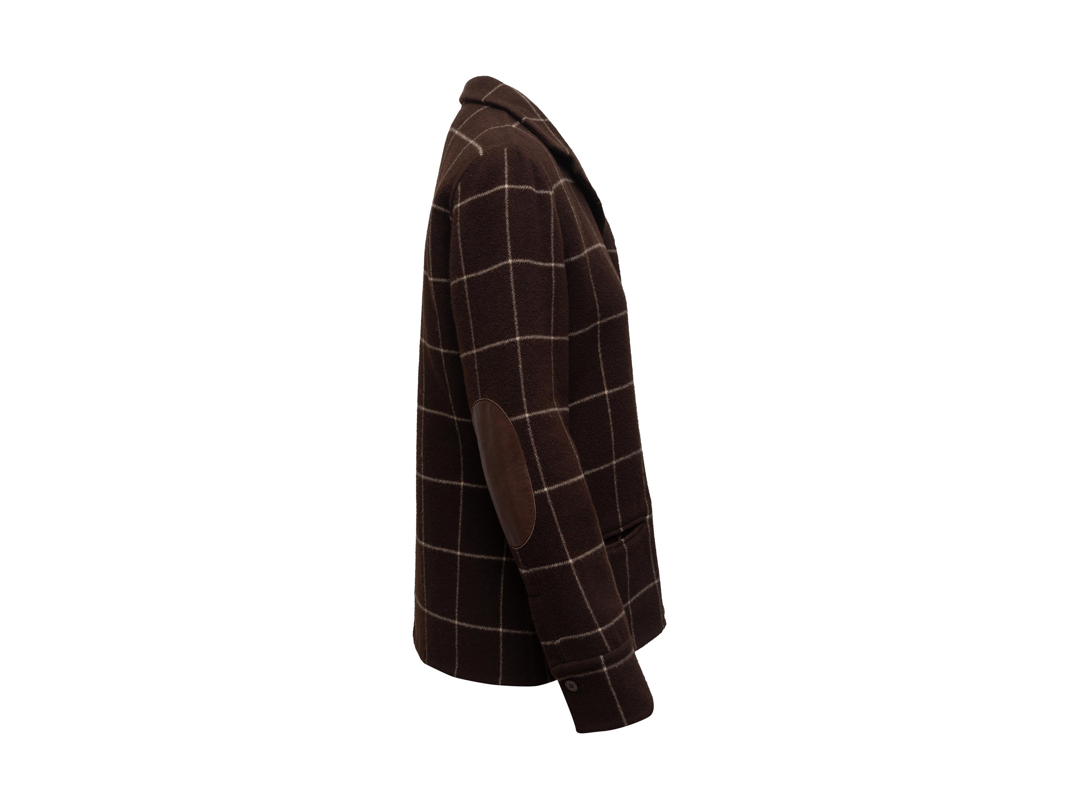 Product details: Brown and white wool grid patten jacket by Ralph Lauren Collection. Leather trim. Pointed collar. Dual welt pockets at hips. Button closures at front. 20