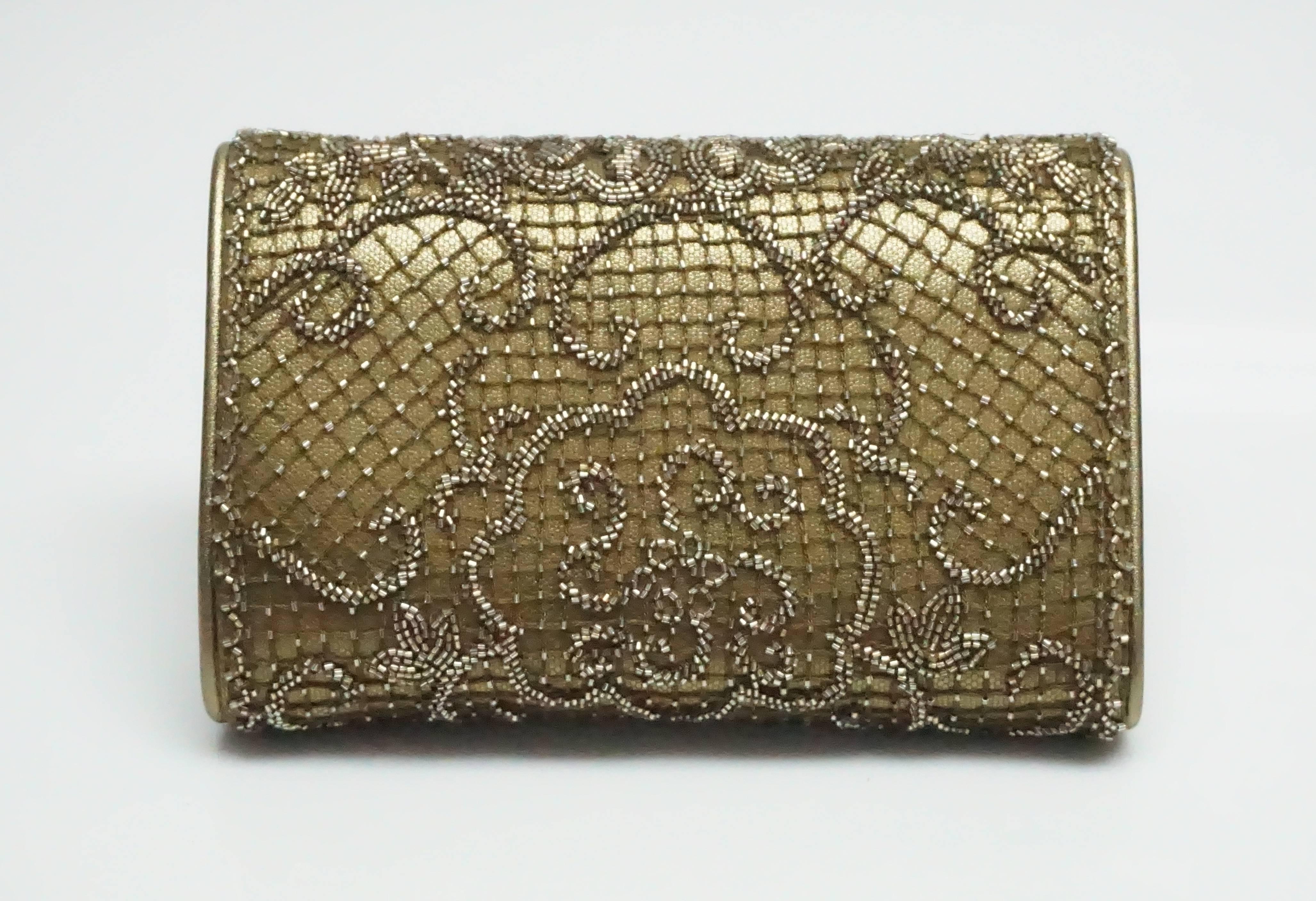 Ralph Lauren Collection Gold/Bronze Leather Beaded Clutch.  This beautiful clutch is new with tags. The clutch is a  gold/bronze metallic color leather with a beaded netting over it. The inside includes one small open pocket. The clutch comes with