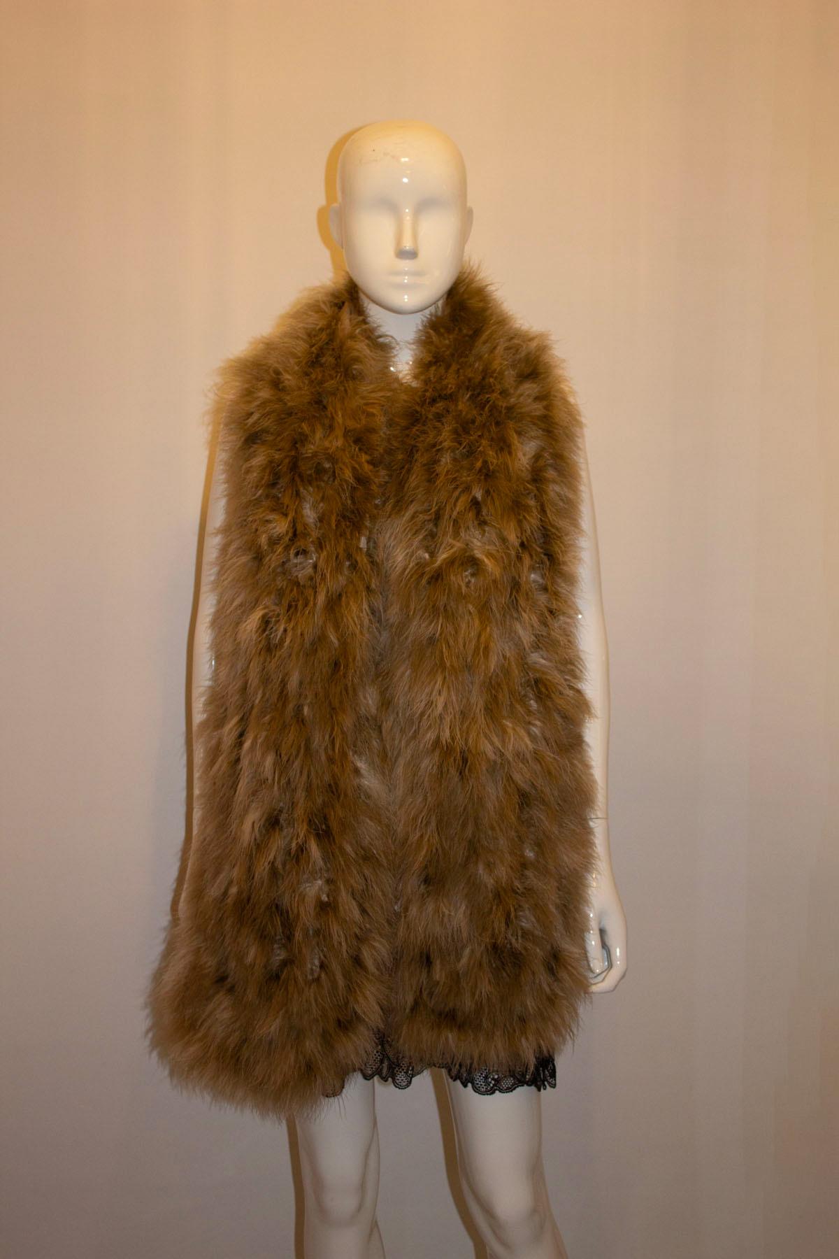 A great addition to any wardrobe, a feather stole/ scarf by Ralph Lauren , collection line. 
The scarf is in a soft brown colour , lined in silk and made in France.
Measurements: length 75'', width 10''.