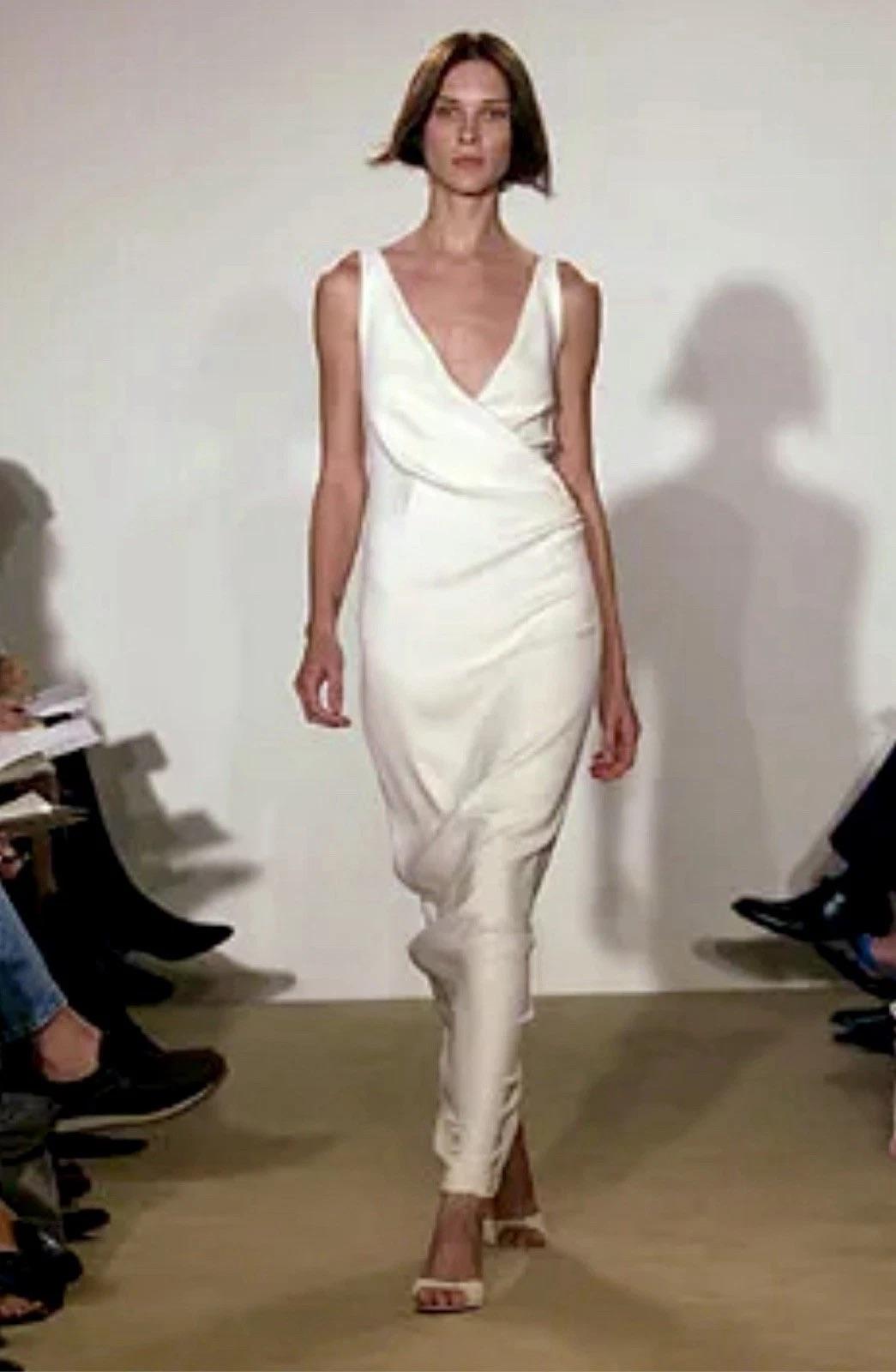 rom Ralph Lauren’s ethereal Spring 2002 runway collection, this ivory silk gown is an understated masterpiece of bias-cut elegance. Crafted in luxurious silk charmeuse, the dress features a softly draped V-neckline, delicate straps, and a striking