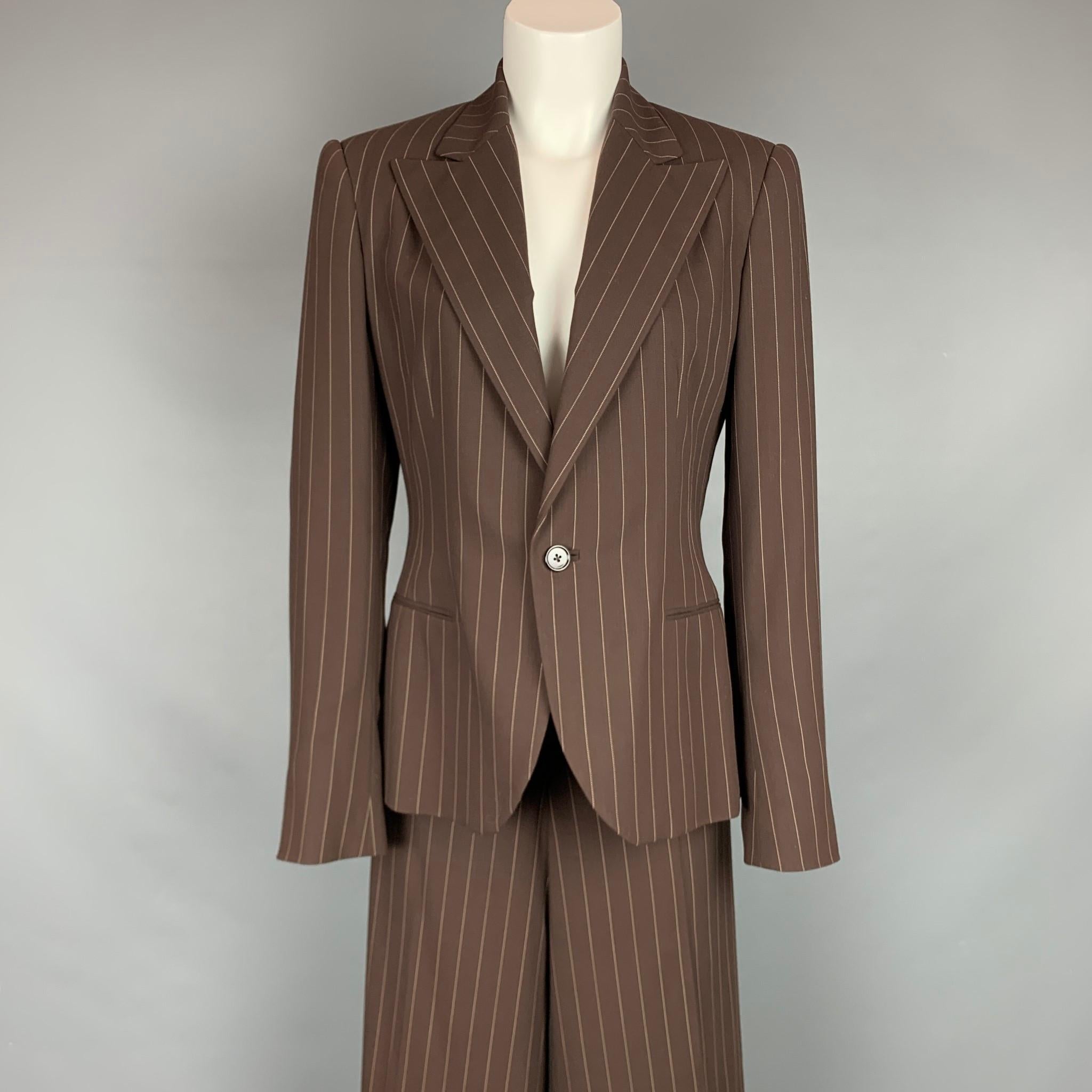 RALPH LAUREN Collection suit comes in a brown & cream pinstripe virgin wool with  full liner featuring a peak lapel, slit pockets, single button closure, and matching wide leg pants.

Very Good Pre-Owned Condition.
Marked: