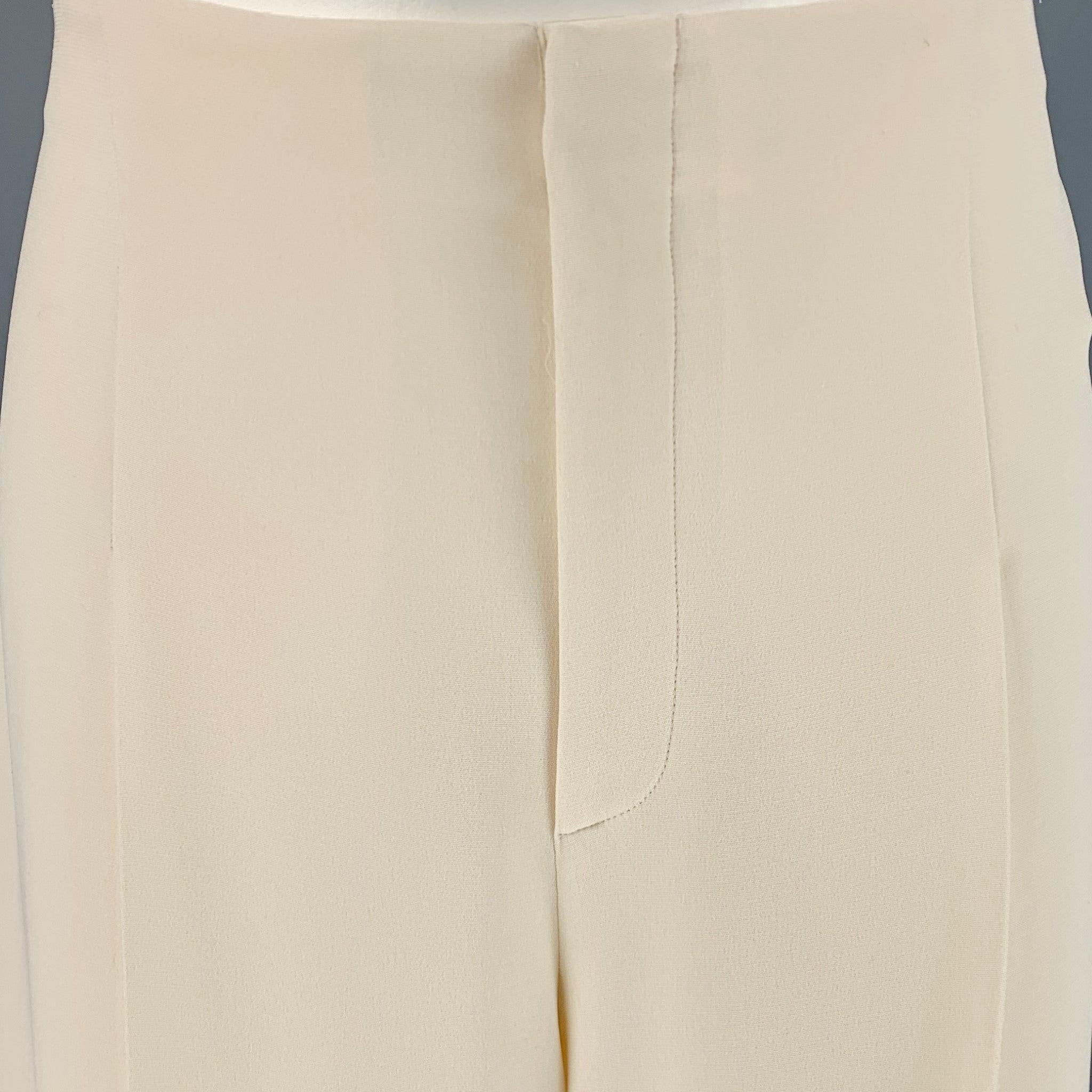 RALPH LAUREN COLLECTION dress pants
in a
cream silk fabric featuring a wide leg style, single pleat, silk lining, and zip fly closure. Made in Italy.Very Good Pre-Owned Condition. 

Marked:   XS 

Measurements: 
  Waist: 32 inches Rise: 13 inches