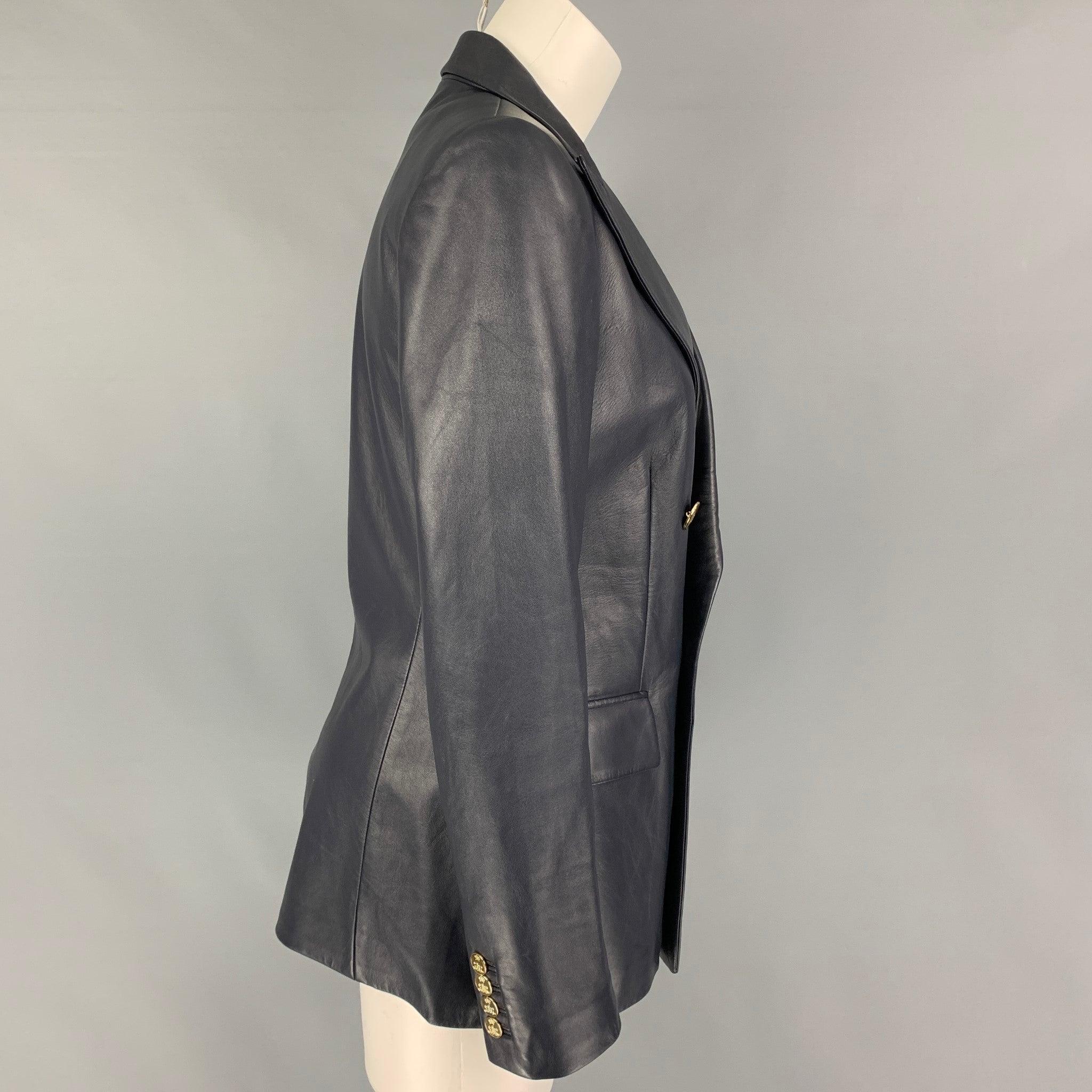 RALPH LAUREN Collection 'Camden' jacket comes in a navy lamb skin leather with a full liner featuring a peak lapel, flap pockets, and a gold tone double breasted closure. Made in Italy.
Very Good
Pre-Owned Condition. 

Marked:   8 

Measurements: 
