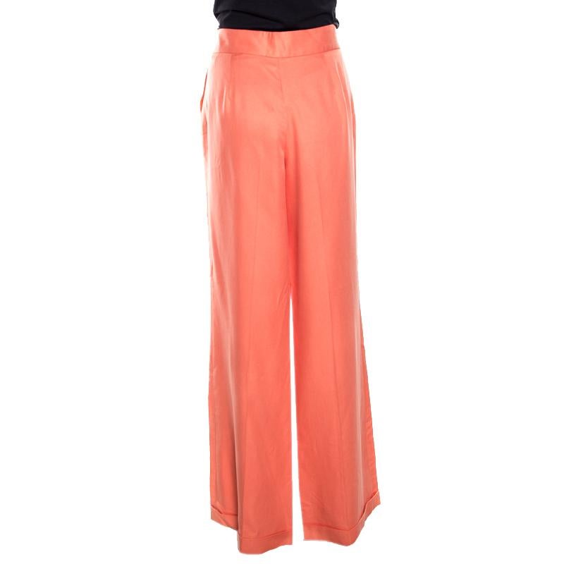 Wide leg pants are coming back on trend and we couldn't be happier. These from Ralph Lauren have been tailored from silk and feature a perfect fit along with side button details. These coral-coloured beautiful pants can be worn with a belted top and
