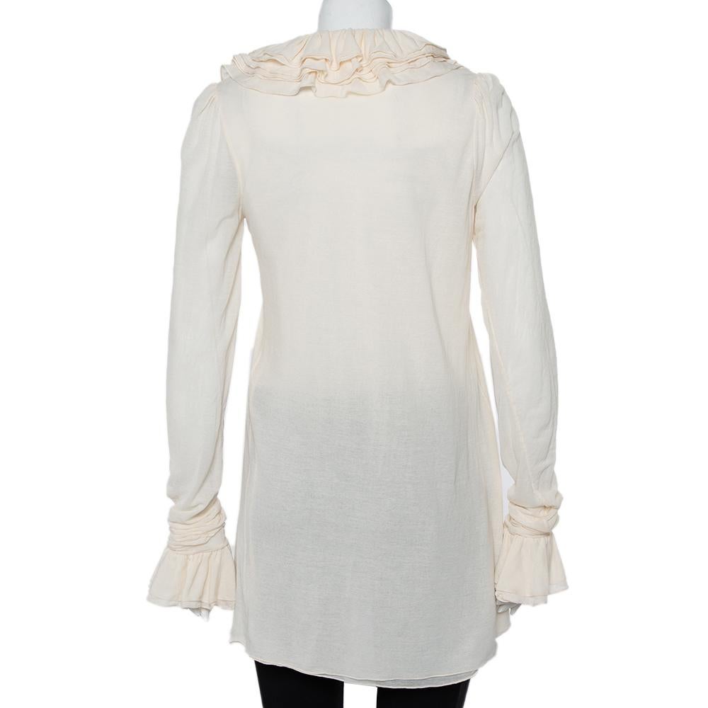 You cannot go wrong with an impressive ensemble like this one from Ralph Lauren! Step out in confidence when you wear this cream tunic. This amazing creation features ruffle details on the neckline and the long sleeves and will look great with