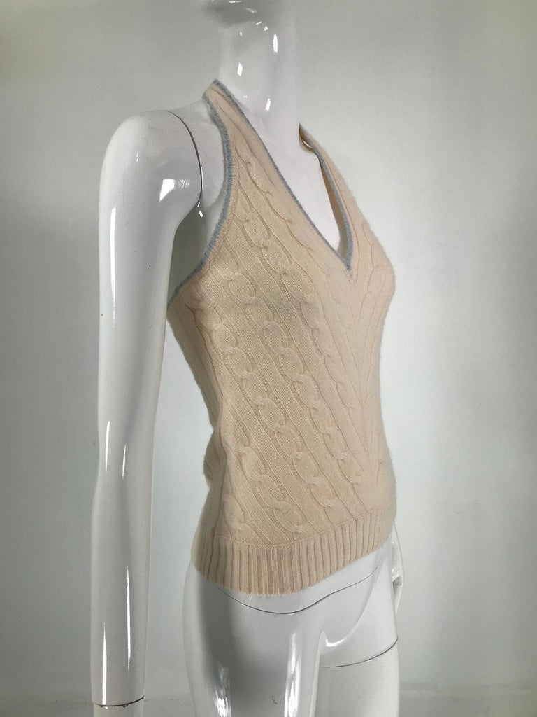 Ralph Lauren cream & sky blue cashmere cable knit halter top. Soft cashmere halter with a narrow band of sky blue cashmere knit trim. Cream cashmere with v neck, cables front and back and ribbed waist. Marked size medium, fits a size 4.
      In