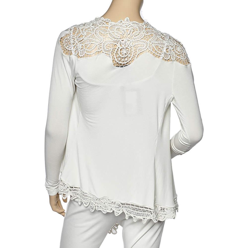 Complement your subtle style with this smart and elegant shrug from Ralph Lauren. This piece is designed using cream stretch jersey fabric and flaunts intricate crochet trims, long sleeves, and an open front. Put together a chic ensemble by wearing