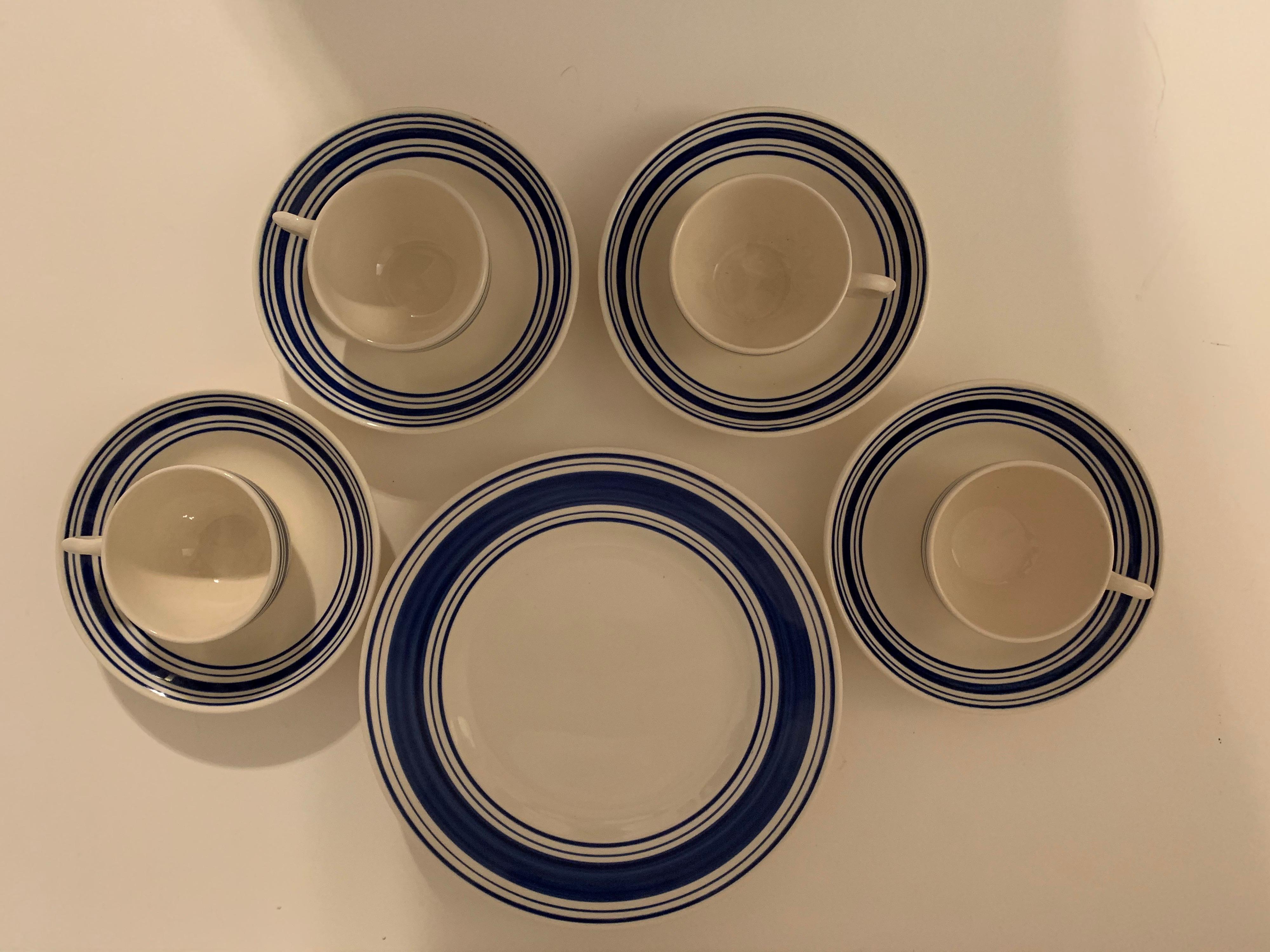 A 12 piece dinnerware set in the Farmstead blue and white pattern by Ralph Lauren Home collection. Signed. Ironstone. Made in England; circa 1990.

Features a blue and white ticking-inspired striped border on white.

Includes the follow 12 pieces:
4