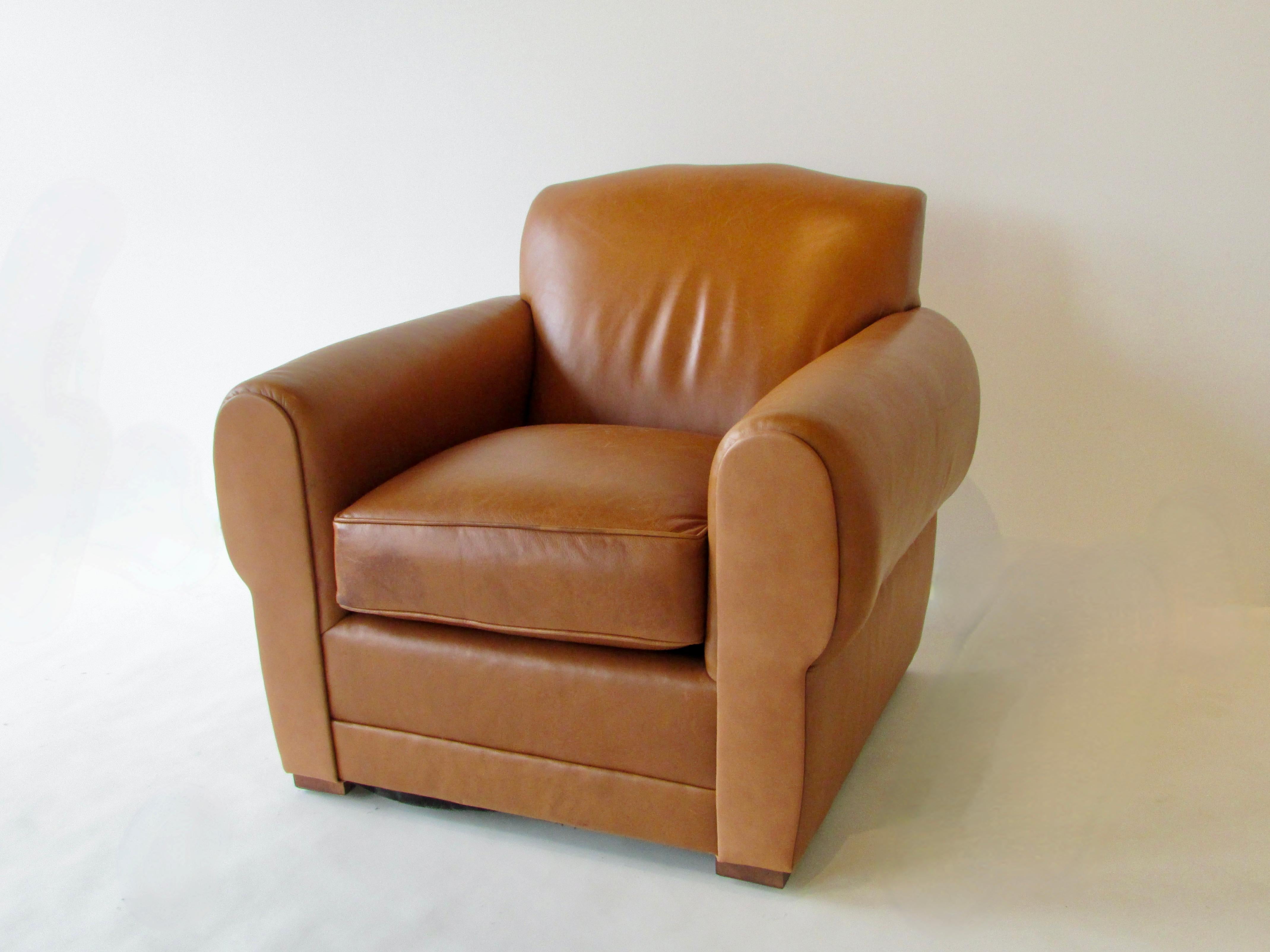 Ralph Laurens styling of a French style Art Deco club chair. Covered in soft supple natural tone leather. Grand and comfortable. There are some scuffs and dark areas . The chair will take on patina as the years go by . 36