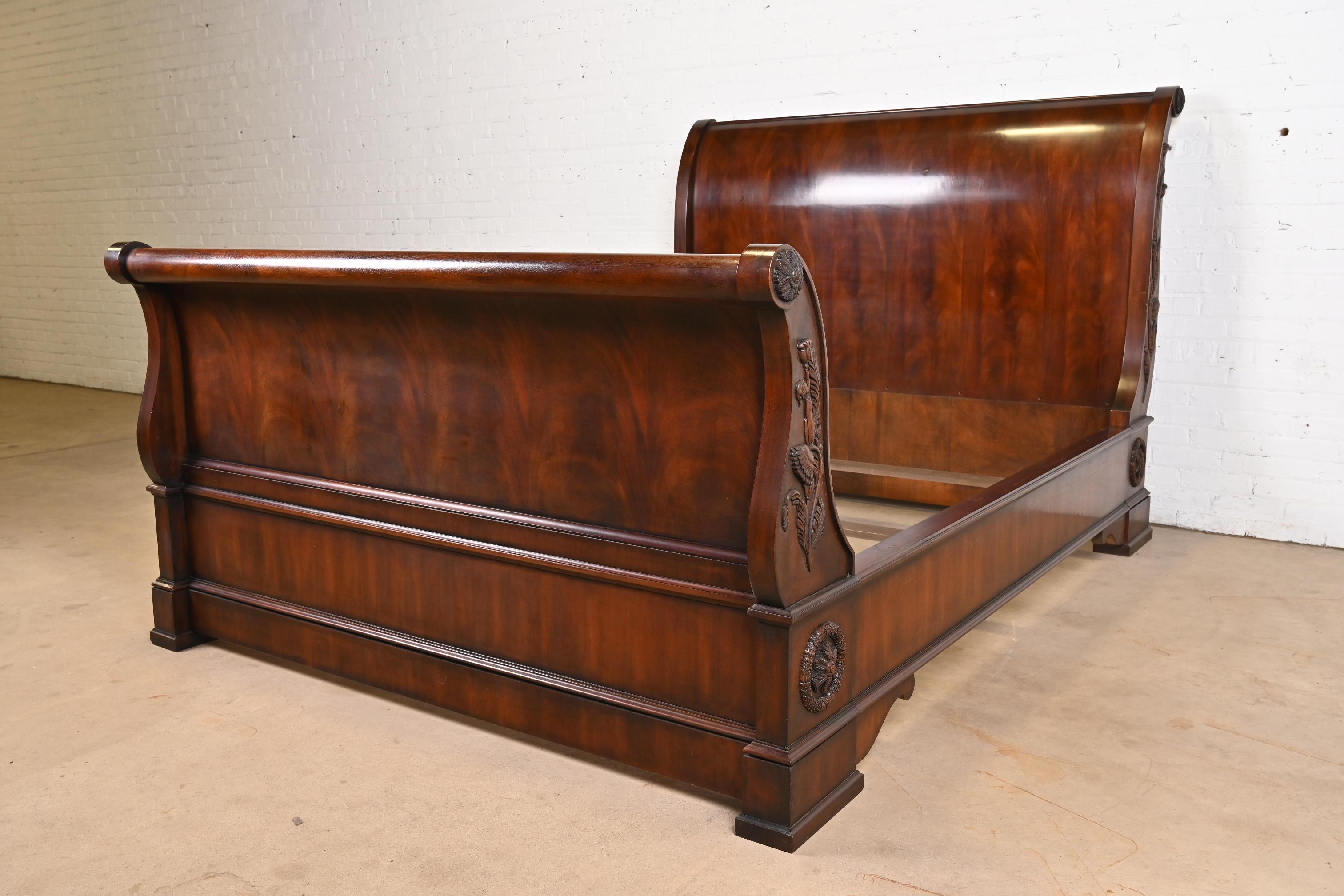 A gorgeous French Provincial Louis Philippe or Empire style queen size sleigh bed

By Ralph Lauren

USA, Late 20th Century

Stunning book-matched flame mahogany, with ornate floral carvings.

Measures: 69