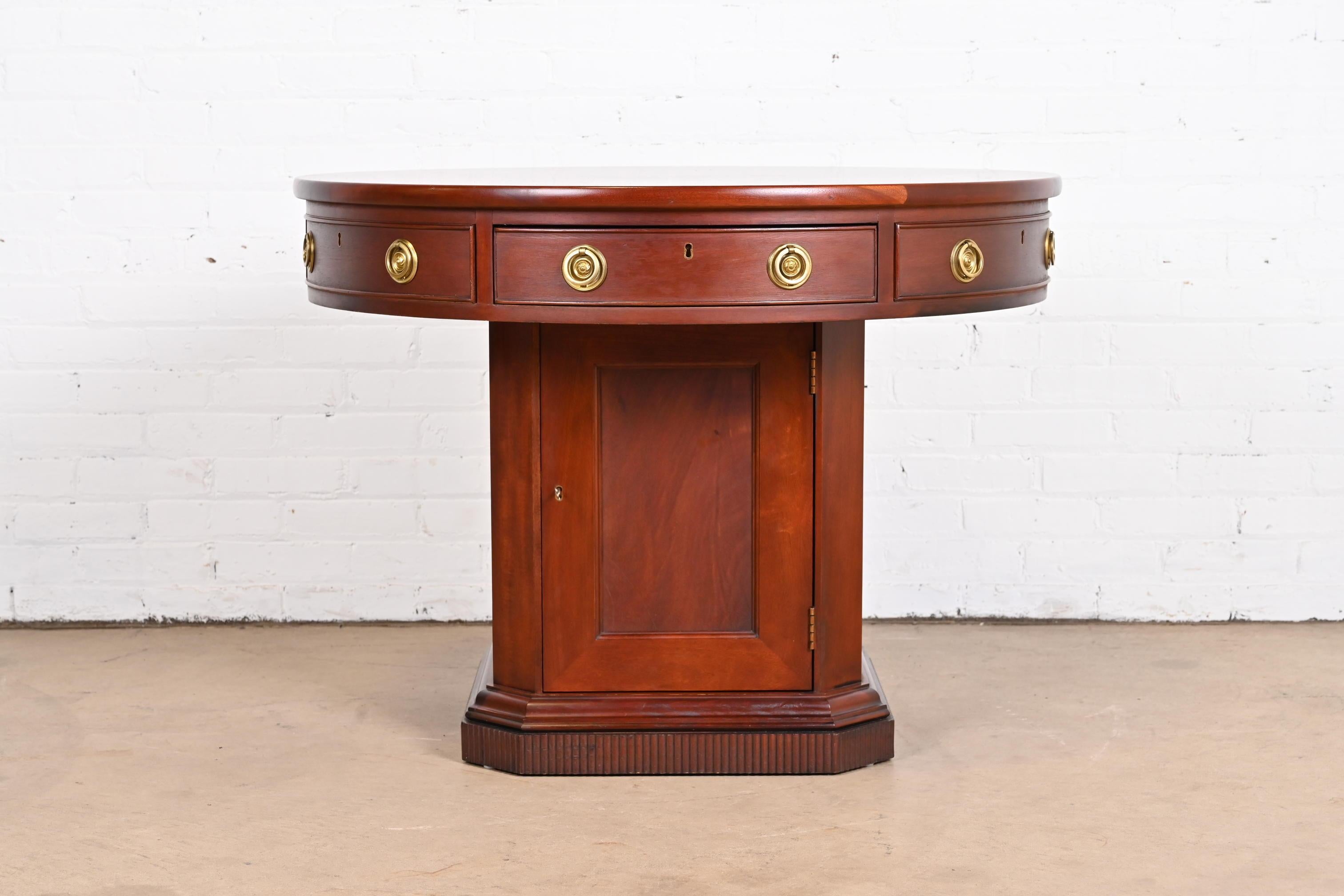 A gorgeous Georgian style drum shaped rent table or center table. Would also make a great bar cabinet and serving table.

by Ralph Lauren

Late 20th Century

Mahogany, with original brass hardware. Lower cabinet locks, and key is
