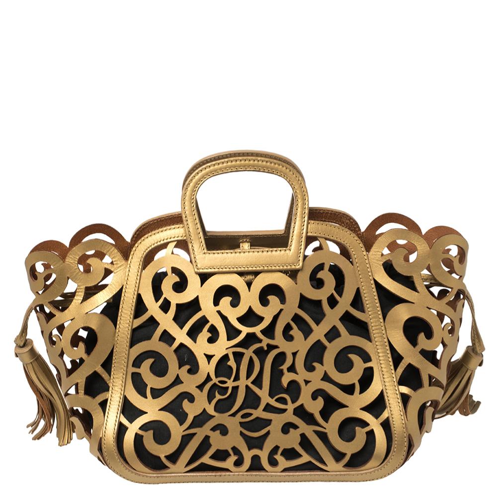 Transforming dainty detailing into close-up designs made from leather and matching or contrasting almost any outfit to perfection, this Ralph Lauren tote is a beauty for keeps. Its gold leather exterior is perforated with swirls and side tassels,