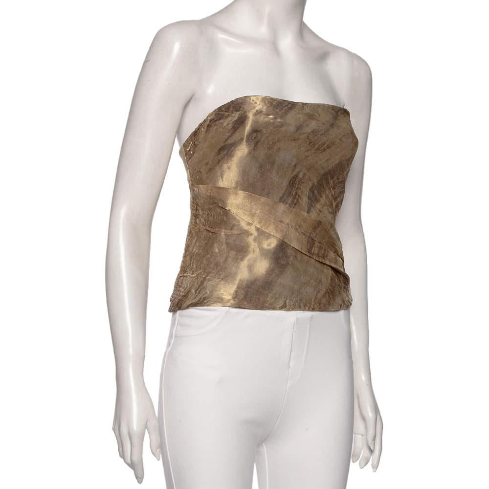 Your style will sparkle and look glamorous as you wear this beautiful top from the House of Ralph Lauren. Fashioned in gold patterned mesh and silk fabric, this top features an audacious strapless style with a zip-type fastening on the side. Let