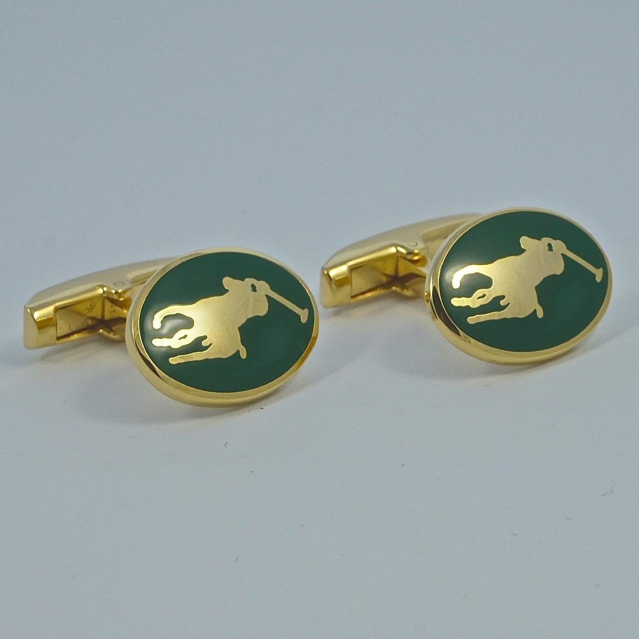 Ralph Lauren gold plated and green enamel polo cufflinks. Measuring 1.9cm / .75 inch by 1.4cm / .55 inch. The cufflinks are marked for Ralph Lauren, Made in England. They are in very good condition, and will arrive in their original Ralph Lauren