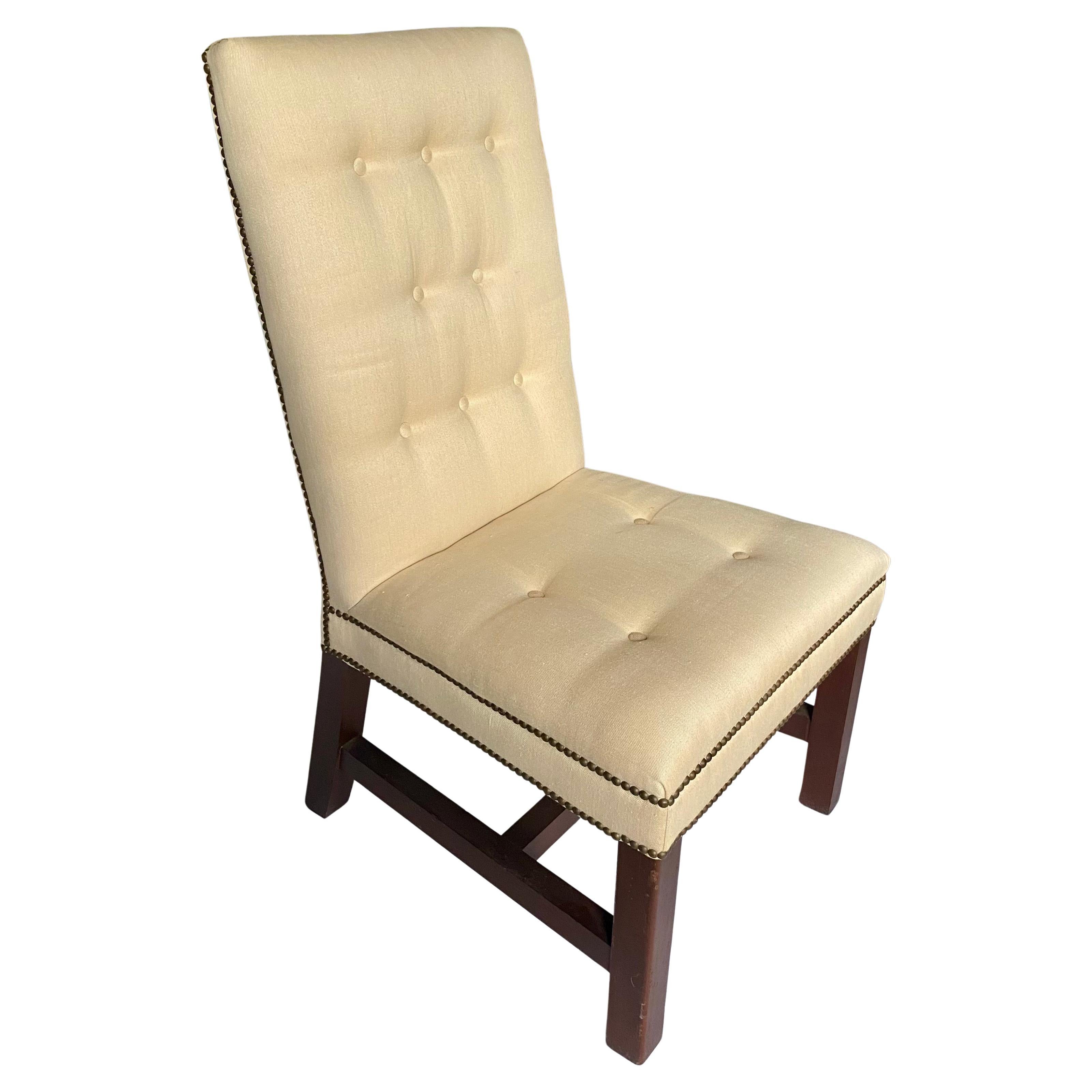 Set of 6 classic high-back dining side chairs by Ralph Lauren.  These handsome generously sized dining chairs feature tufted backs and seats, aged brass nail head trim, and square mahogany-stained legs with H stretcher bases.   These timeless