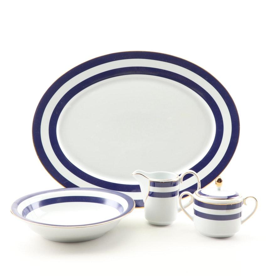 A four-piece porcelain serving platter in the Spectator cadet blue pattern by Ralph Lauren Home Collection for Wedgwood. Signed, circa 1995-1996.

Includes oval serving platter, vegetable serving bowl, creamer and lidded sugar bowl.

Features a