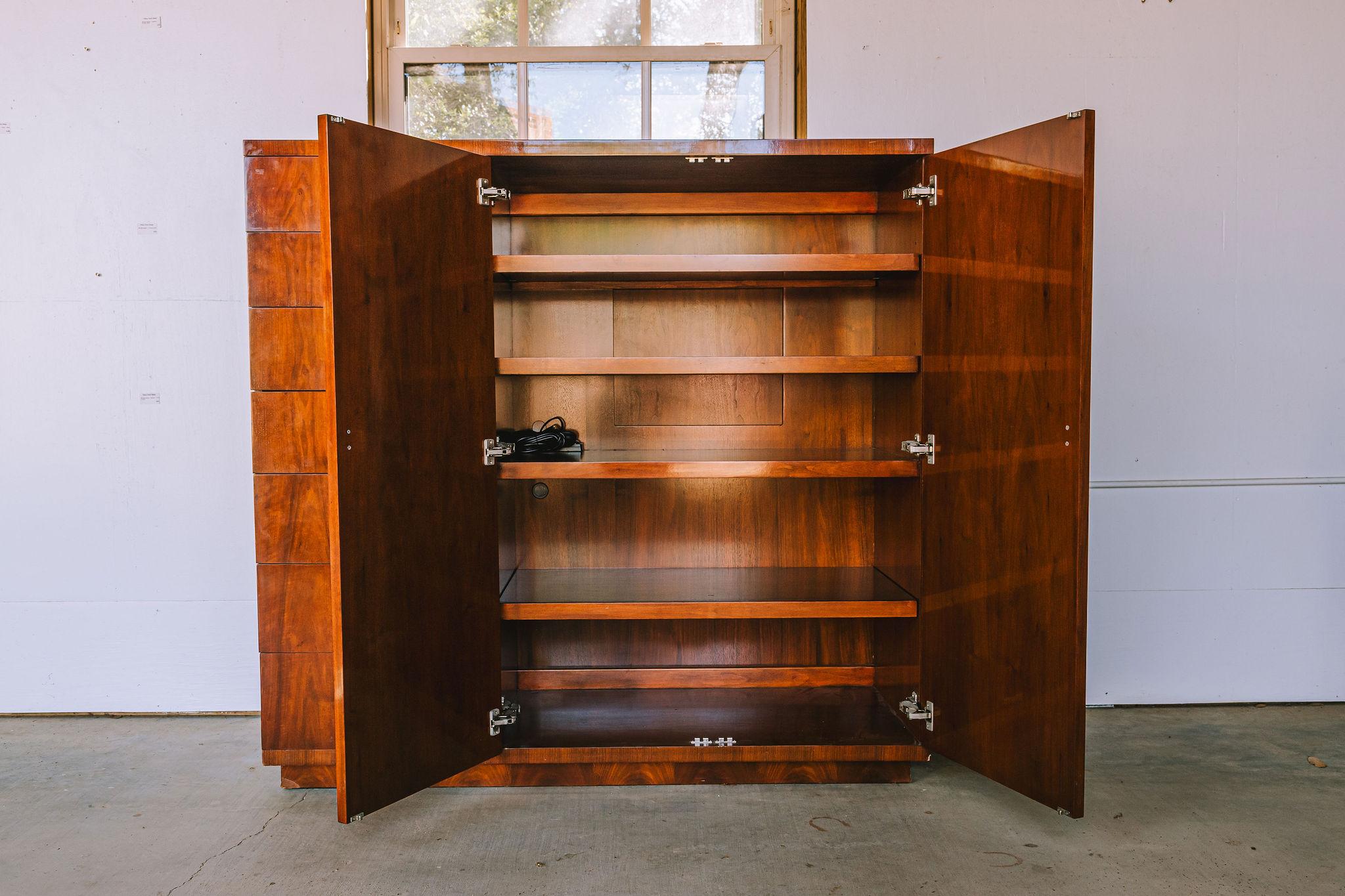 Stunning Ralph Lauren Gentlemen's Chest with Drawers and Cabinet.


This Handsome Chest  has 8 Sliding drawers on the left side.  On the right side the doors open to  2 large shelves with an armoire style space. Sliding back wall to open up the back