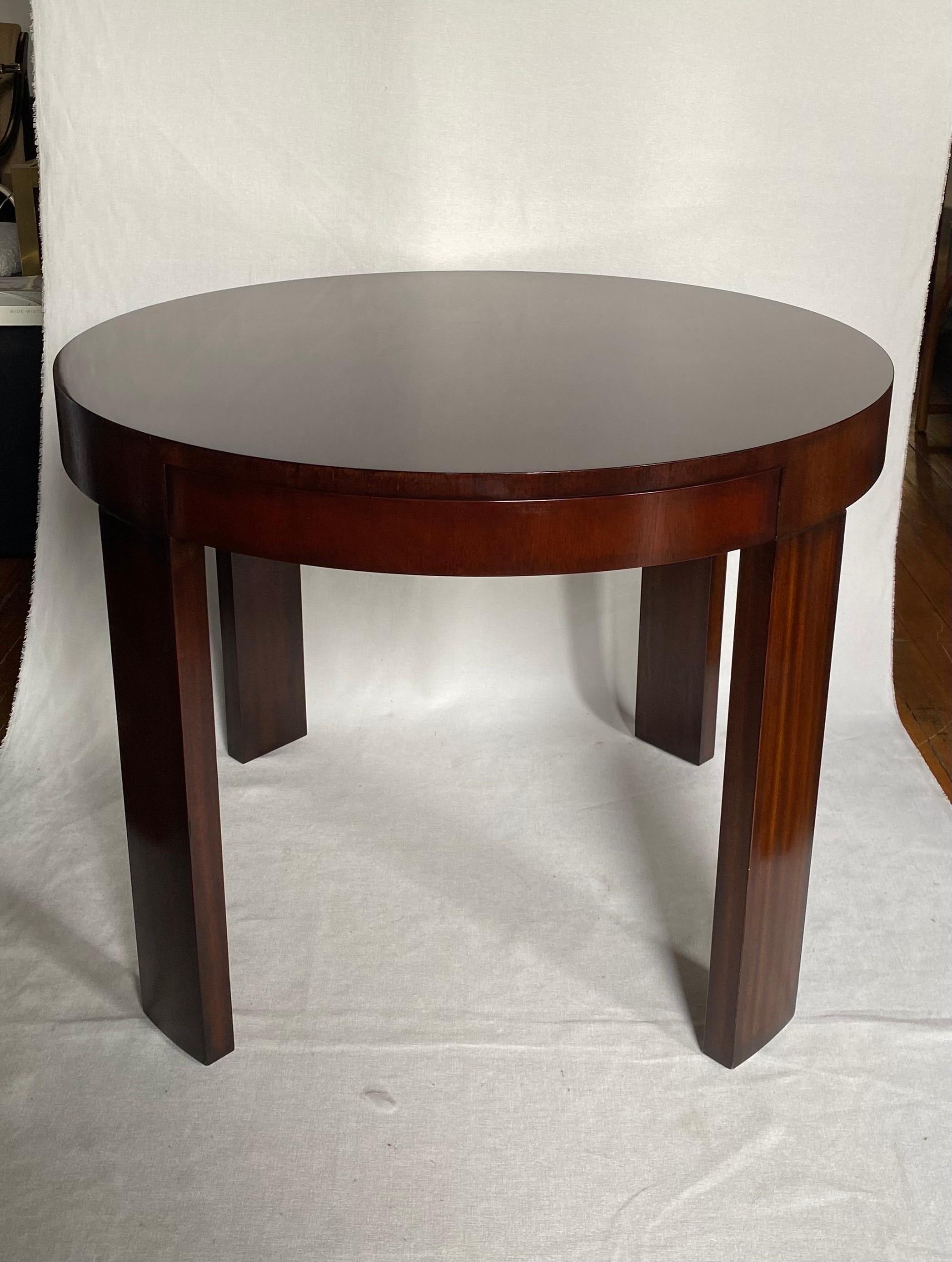 Ralph Lauren Home Beekman bedside or center table.  This handsome round accent table blends traditional and modern styling and features beautifully grained mahogany wood in a high gloss reflective finish.  This large sleek 38