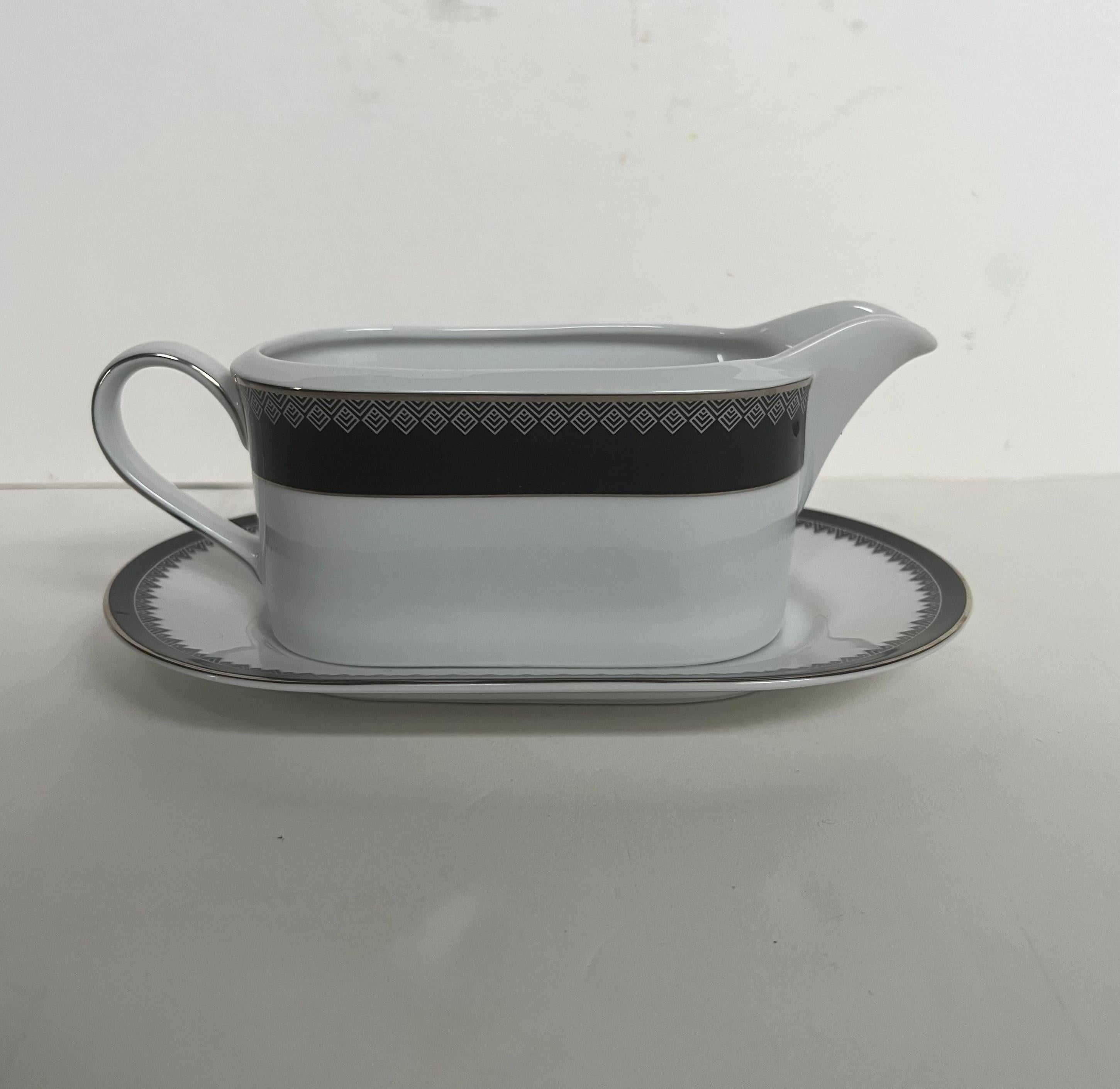 Lauren by Ralph Lauren bone china gravy boat and separate underplate in the Hastings Ebony pattern.

Signed.

Dimensions: 8-1/8” L x 5-1/4” D x 3-1/4” H.