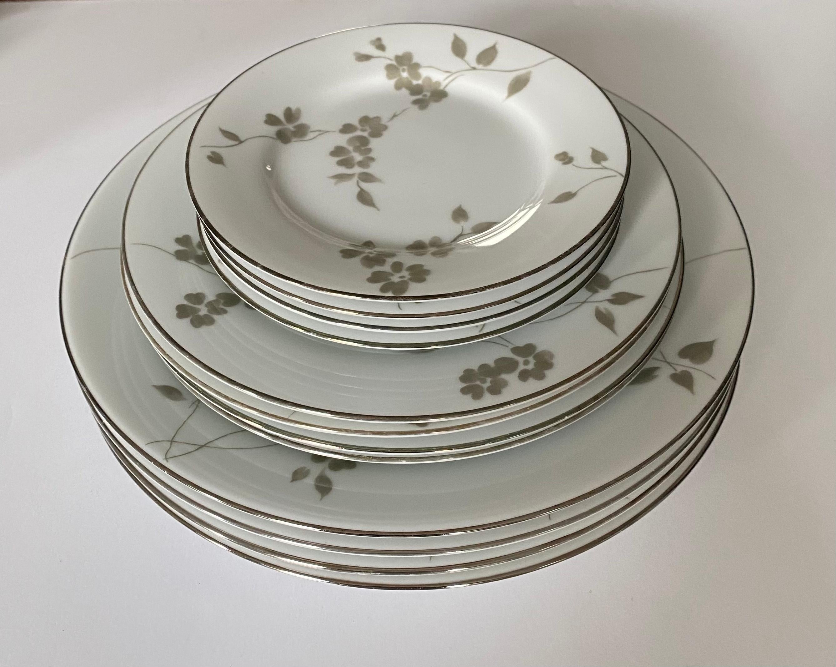 A set of four (4) dinnerware place settings in the Sophia pattern by Ralph Lauren Home. Signed, production period 2000-2002.

Features a delicate floral pattern in gray or green.

Includes 4 place settings. A total of 20 pieces. Each setting