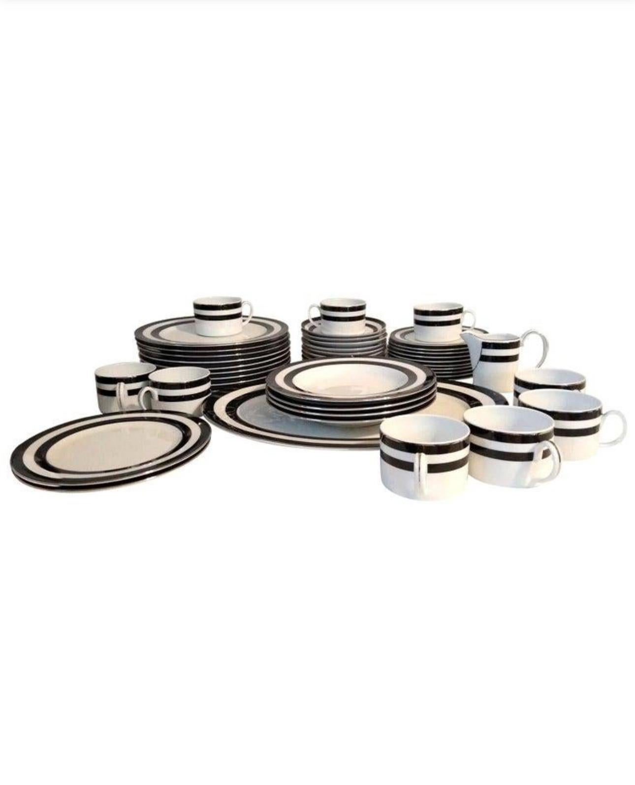 A set of four (4) settings in the Spectator Black pattern by Ralph Lauren Home Collection. Porcelain. Signed, 1995-1996.

White with black wide stripe border and silver trim.

A total of 16  pieces; includes the following:
4 dinner plates
4 salad