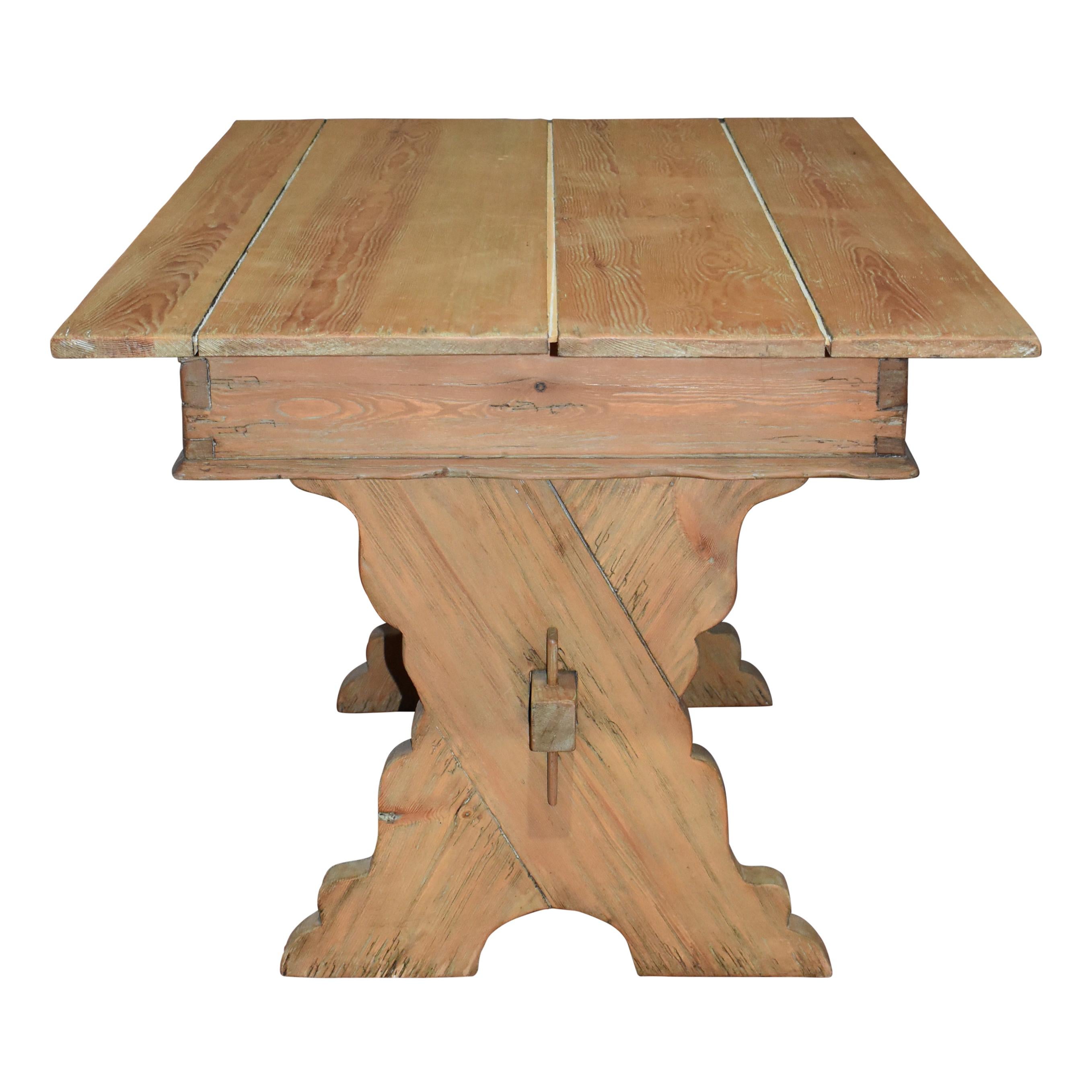Comprised of solid pine, this reproduction of an 18th century, Italian counting table features a sawbuck design with X-shaped legs united by a keyed-Tenon stretcher. The table's planked top can be lifted to reveal a concealed compartment for storage.