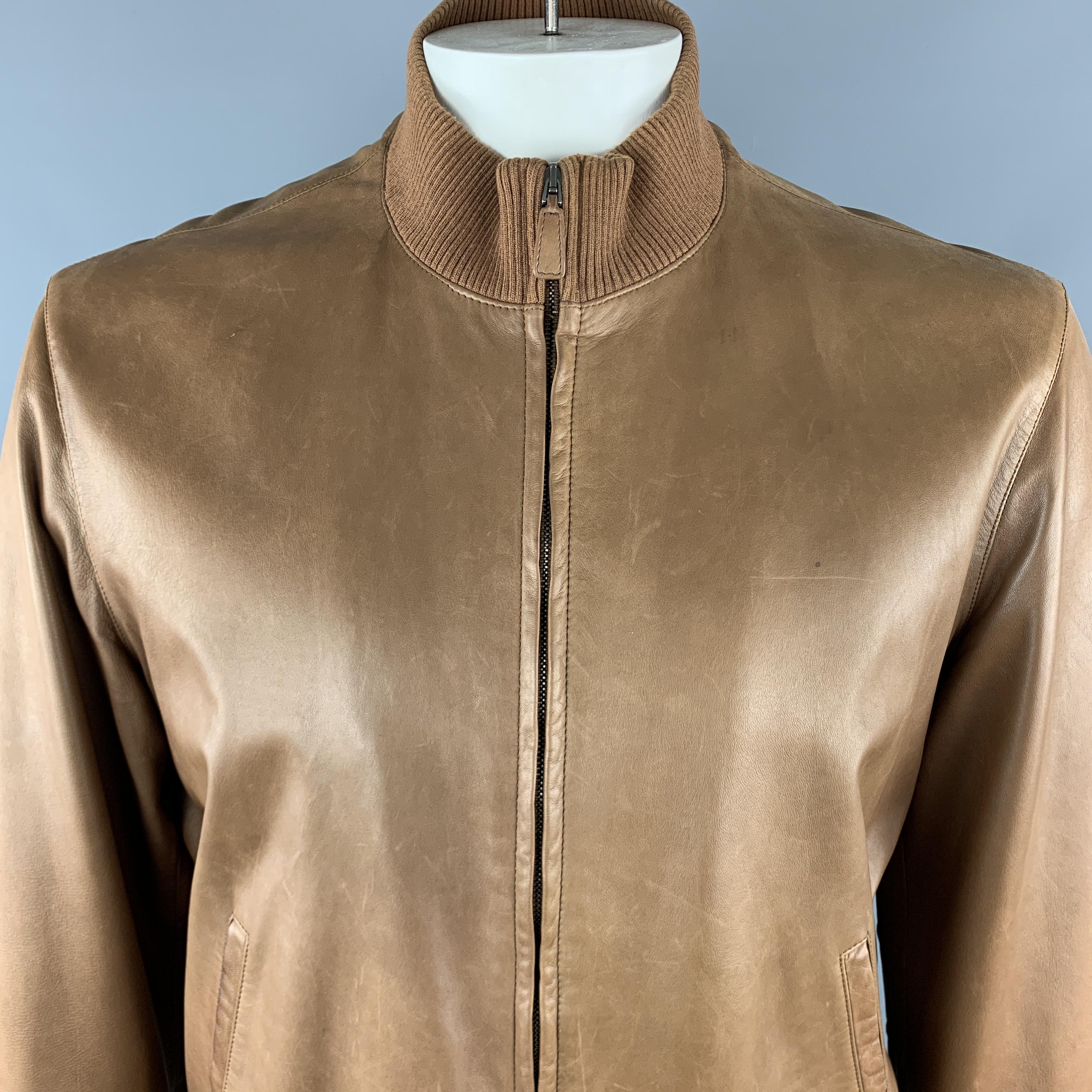 RALPH LAUREN PURPLE LABEL Bomber Style Jacket comes in a tan tone in a solid leather material, with a high collar, zip up, slit pockets, internal pockets and ribbed cuffs and hem. As Is. Made in Italy.

Very Good Pre-Owned Condition.
Marked: