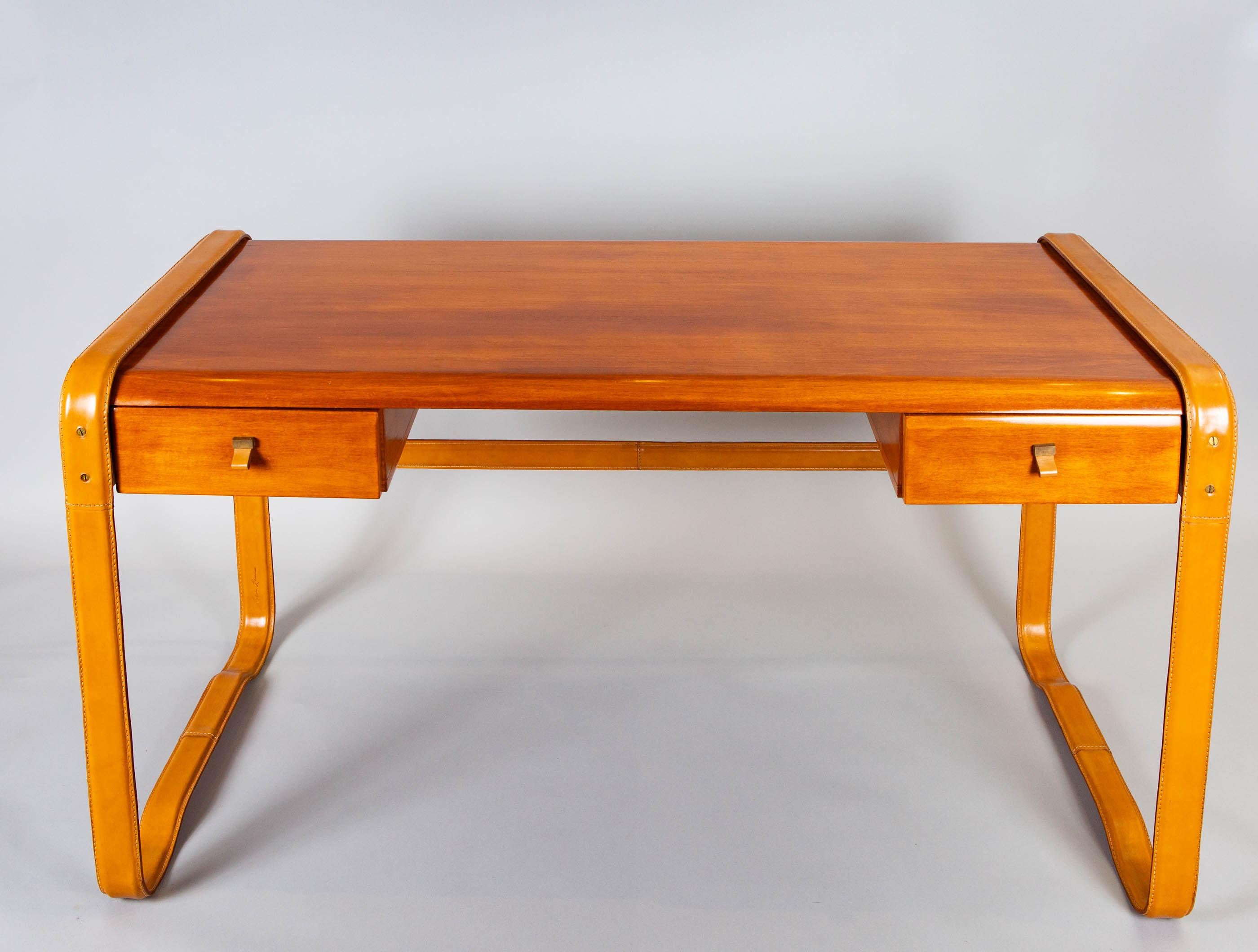 Nice visible stitching and hardware. Signed on back leg. Has two drawers with leather pulls. Top has been recently polished.