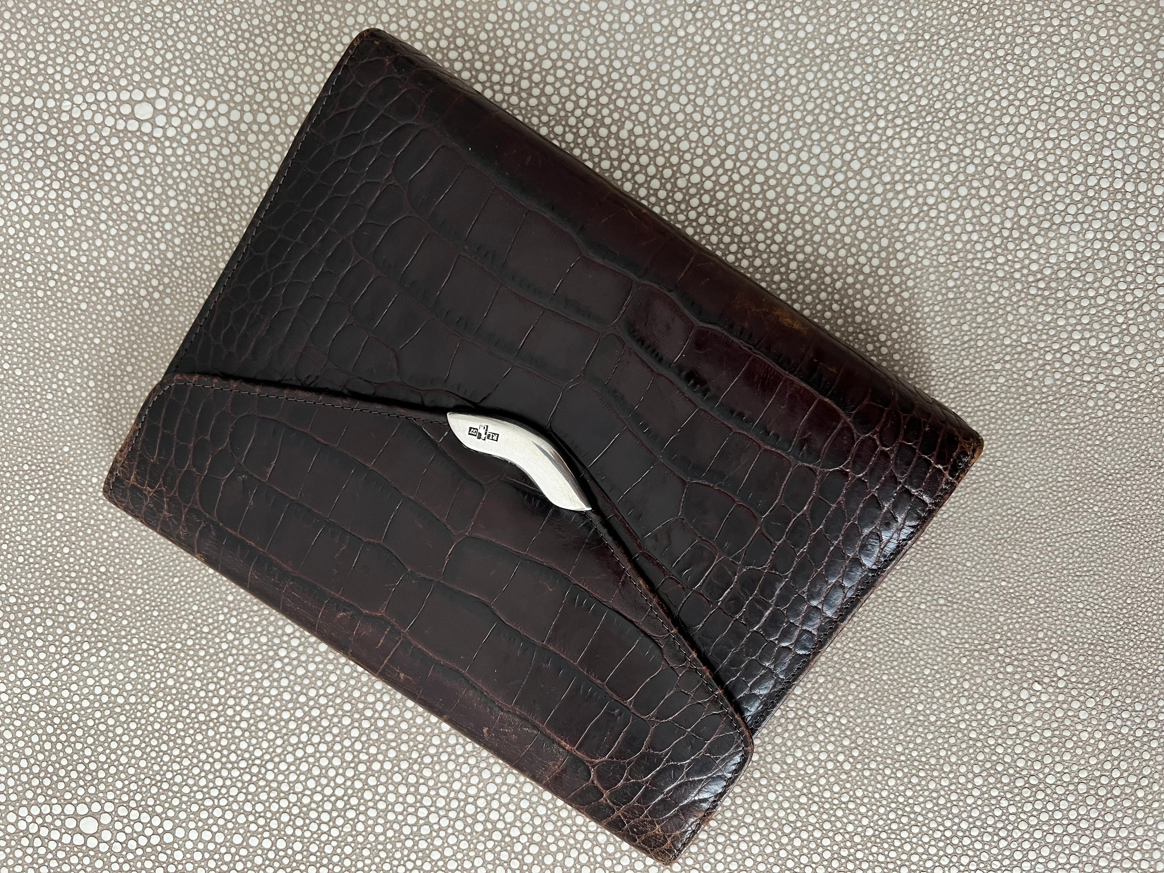 A wonderful Day planner cover.  
The original Stamped crocodile leather is in great condition with rings inside, the ability to hold 5 credit cards, Identification and pockets for papers.

A handsome piece with impressive details