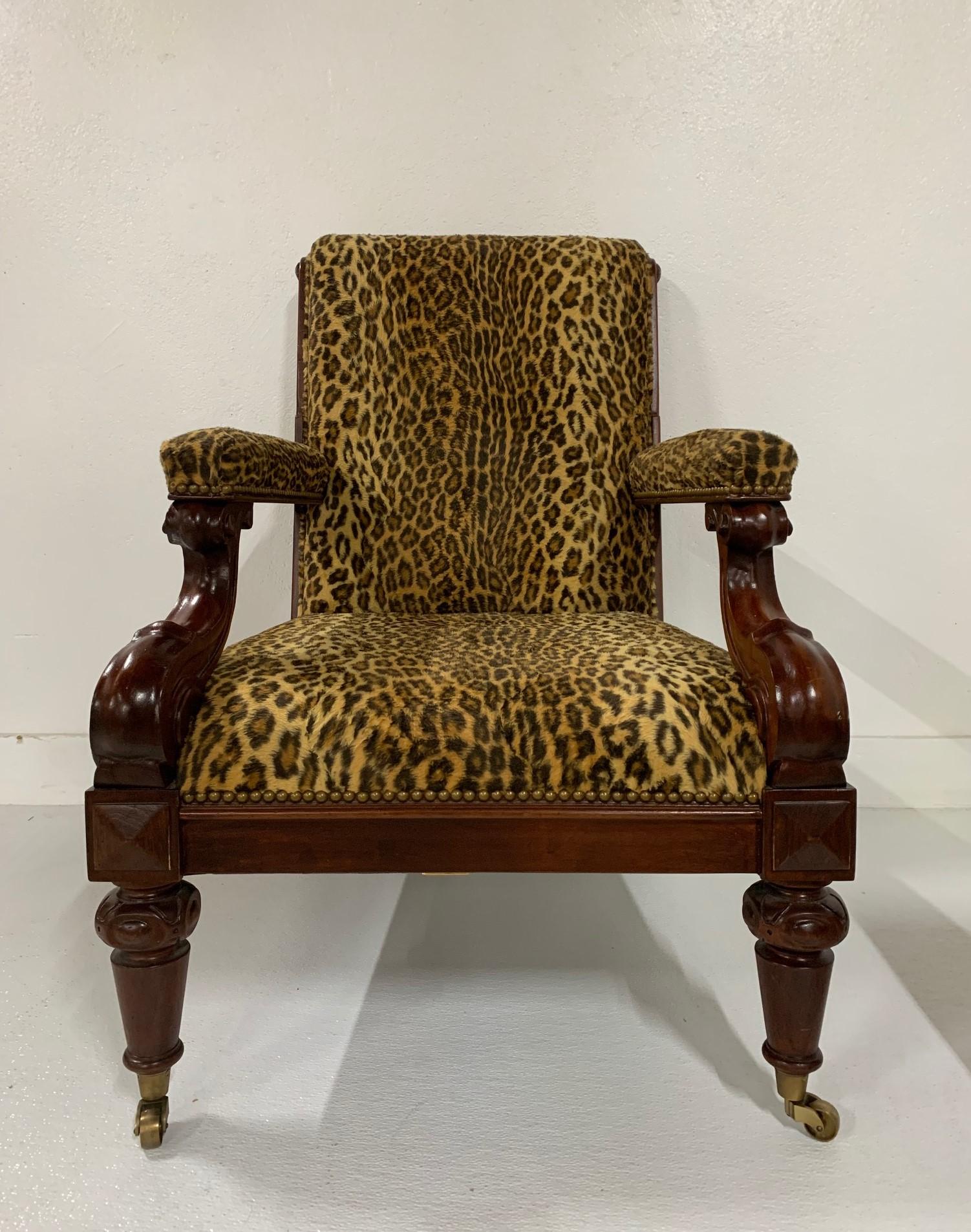 Ralph Lauren mahogany leopard print chair and ottoman. Has a solid mahogany frame, original upholstery and brass casters. Chair has an antique style.
Chair measures: 38.25 H x 27.5 W x 34.25 D. seat height 16.5, ottoman 27.5 square x 16.5 H.
