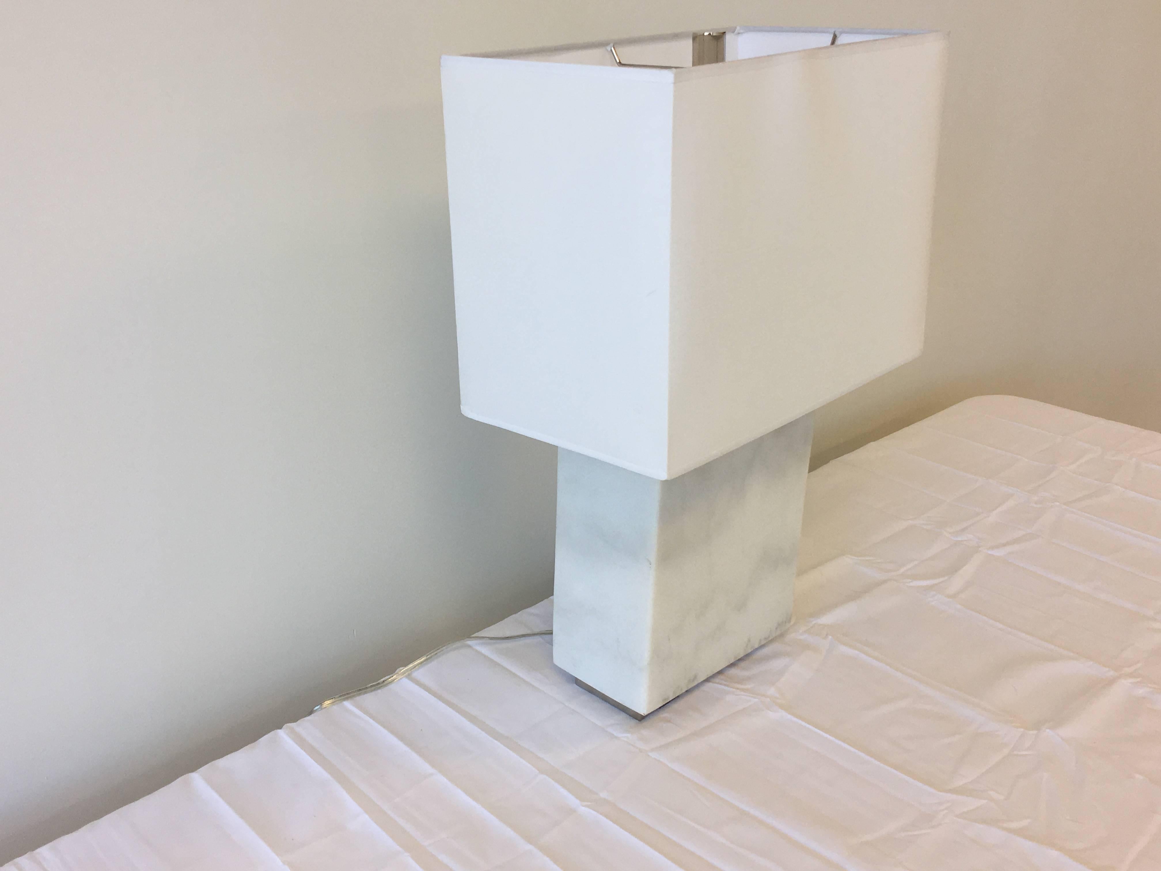 Offered is a fabulous, modern white marble and chrome Ralph Lauren lamp. The base is solid white marble with a chrome plinth raised base. Includes white, rectangular lampshade and chrome finial. Incredibly heavy.

Marked: 