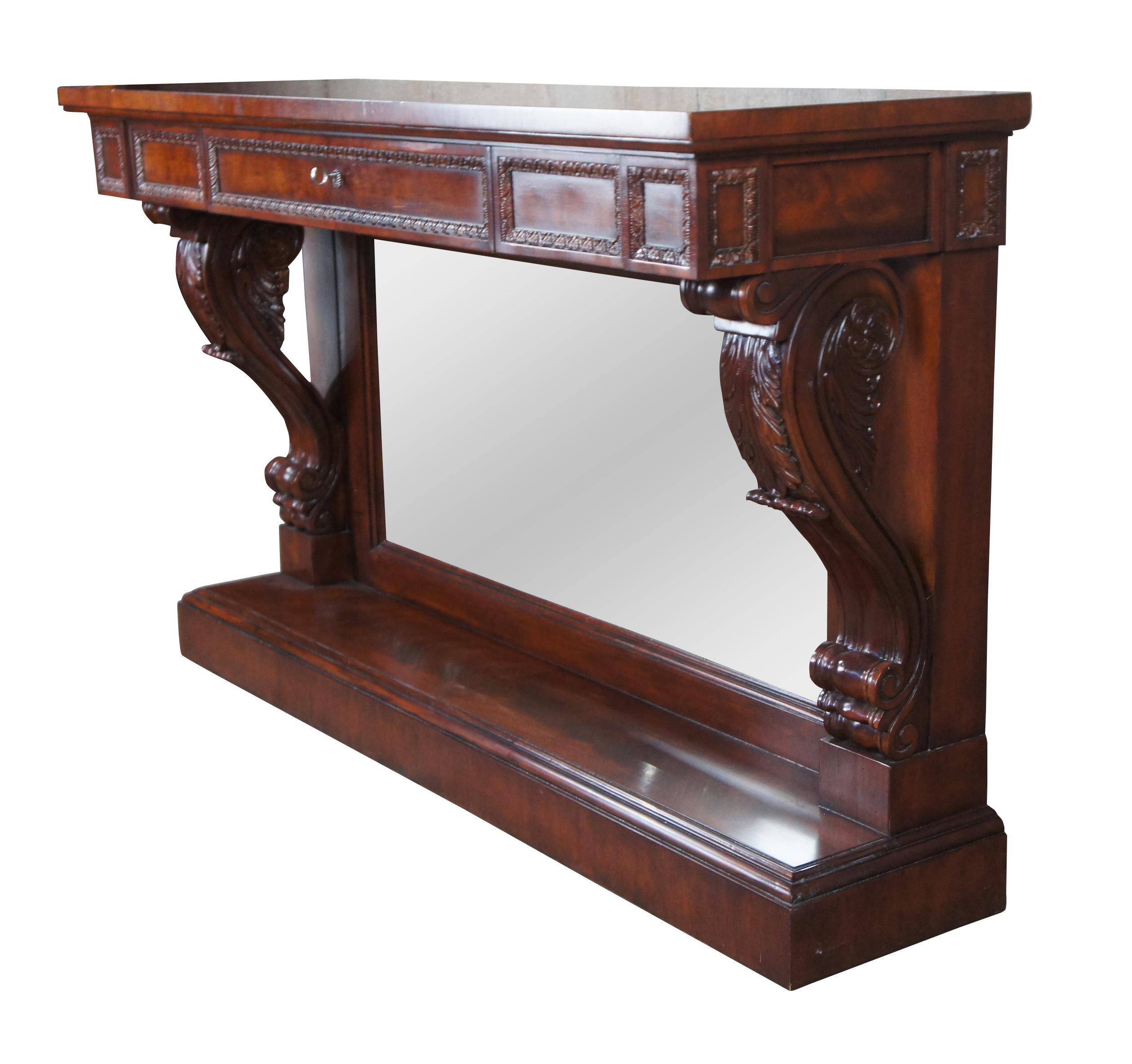 A stately English Regency mirrored pier table by Ralph Lauren, circa 1990s. The rectangular frame is made from a warm brown mahogany with matchbook burled panels. A pronounced top is supported by thick acanthus scrolled corbels over a plinth base.