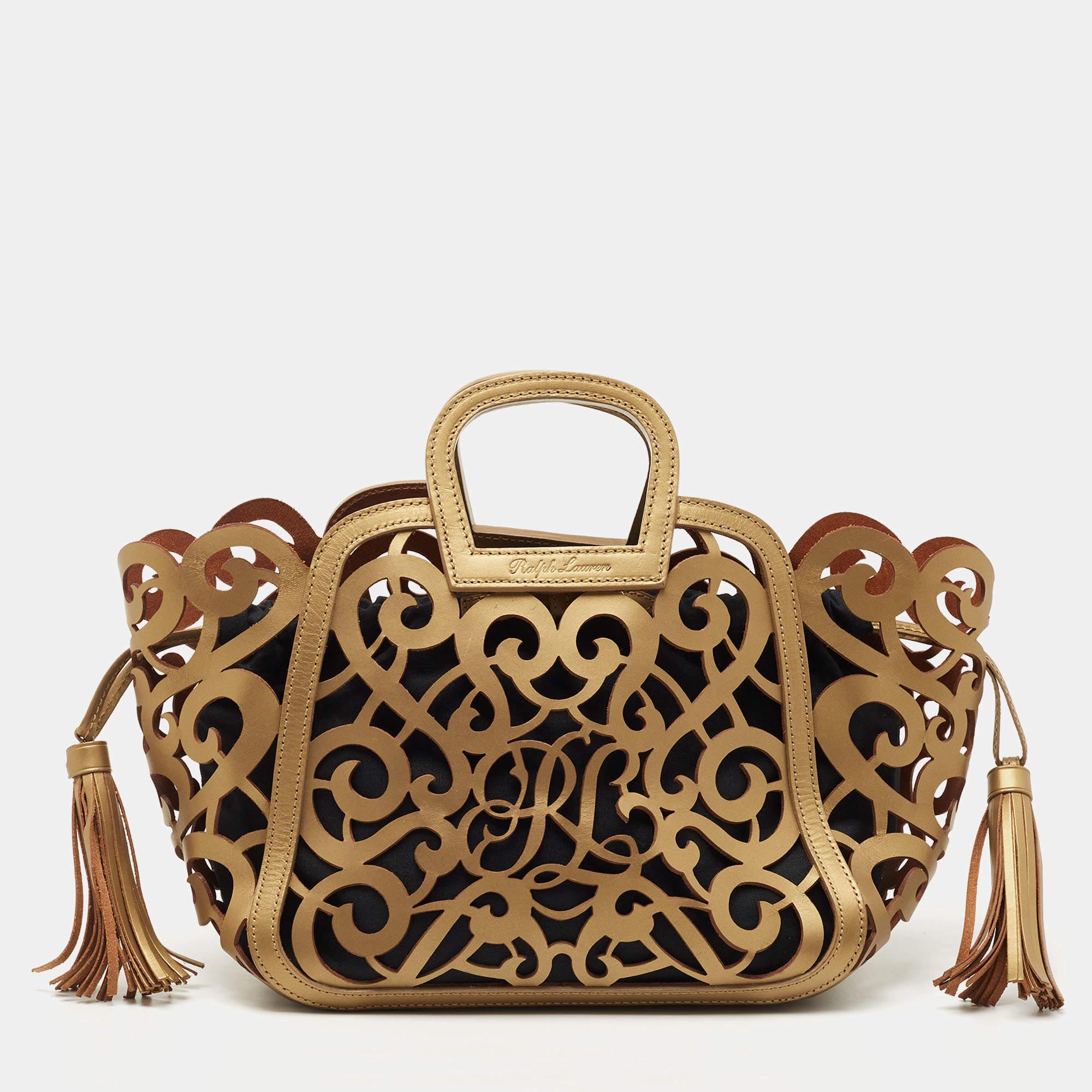 Transforming dainty detailing into close-up designs made from leather and matching or contrasting almost any outfit to perfection, this Ralph Lauren tote is a beauty for the keep. Its gold leather exterior is perforated with swirls and held by two