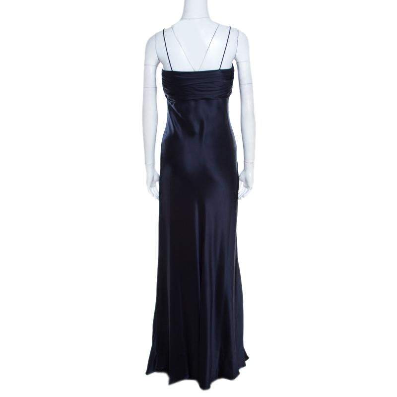 Look your stylish best in this midnight blue gown from the house of Ralph Lauren. Tailored beautifully from silk, the strapless gown has a pleated bandeaux bodice and a lovely skirt that falls gracefully to the floor. A pair of silver sandals will